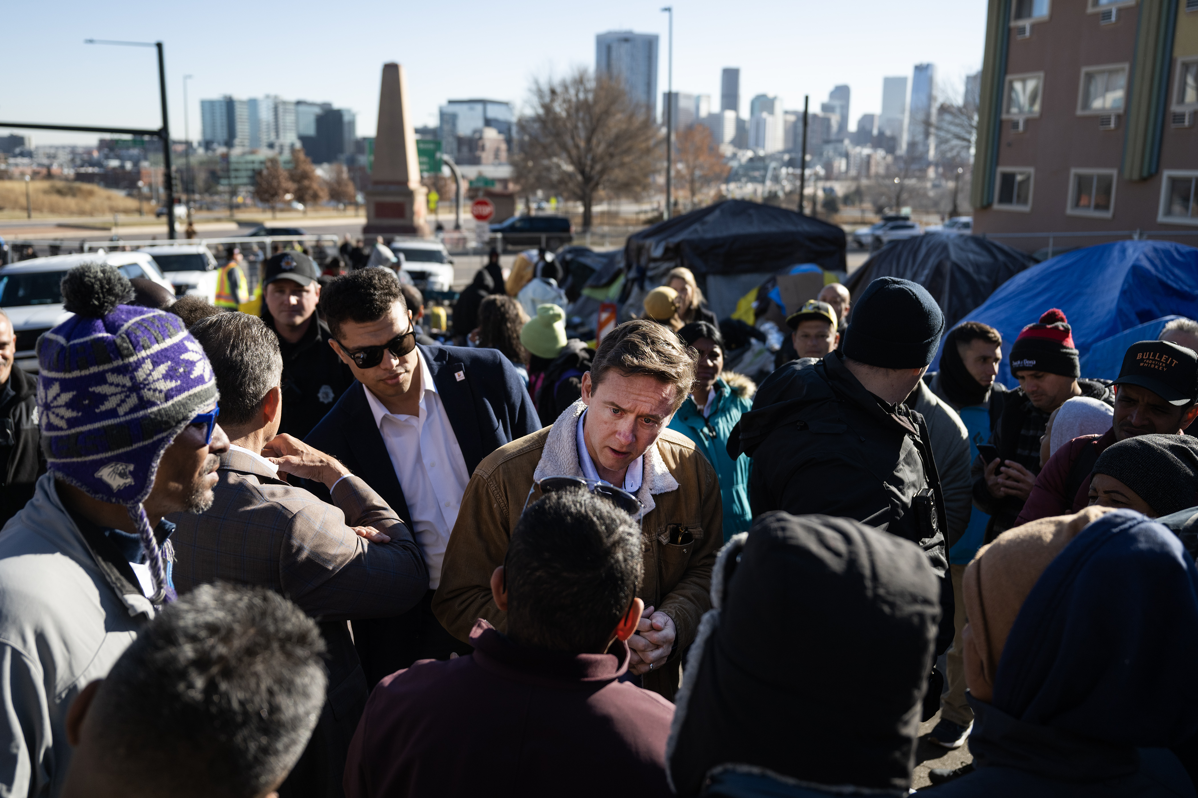 FILE PHOTO: Denver Mayor Mike Johnston, center, talks with immigrants during an encampment sweep at West 27th Avenue, between Zuni and Alcott Streets on Wednesday, Jan. 3, 2024, in Denver, Colo. (Timothy Hurst/Denver Gazette) (TimHursttim.hurst@gazette.comhttps://secure.gravatar.com/avatar/aca82bd62b4ee425c598527cd6faa1b1?d=mm&r=g)