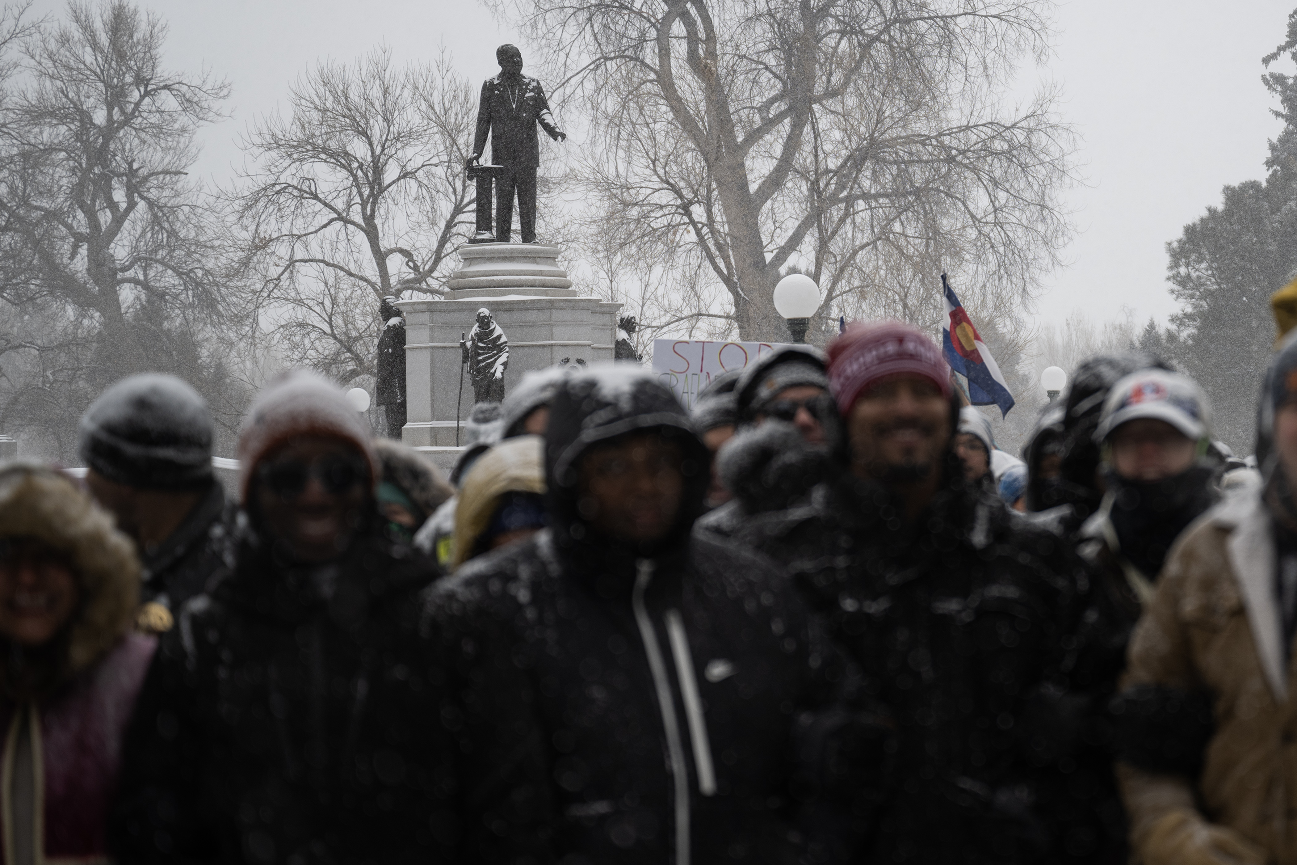 Elected officials and marchers pose for a photo at step-off while the statue of Dr. Martin Luther King Jr. is visible in City Park during Denver's annual Martin Luther King Jr. Day marade on Monday, Jan. 15, 2024, in Denver, Colo.(Timothy Hurst/Denver Gazette) (Timothy Hurst/The Gazette)
