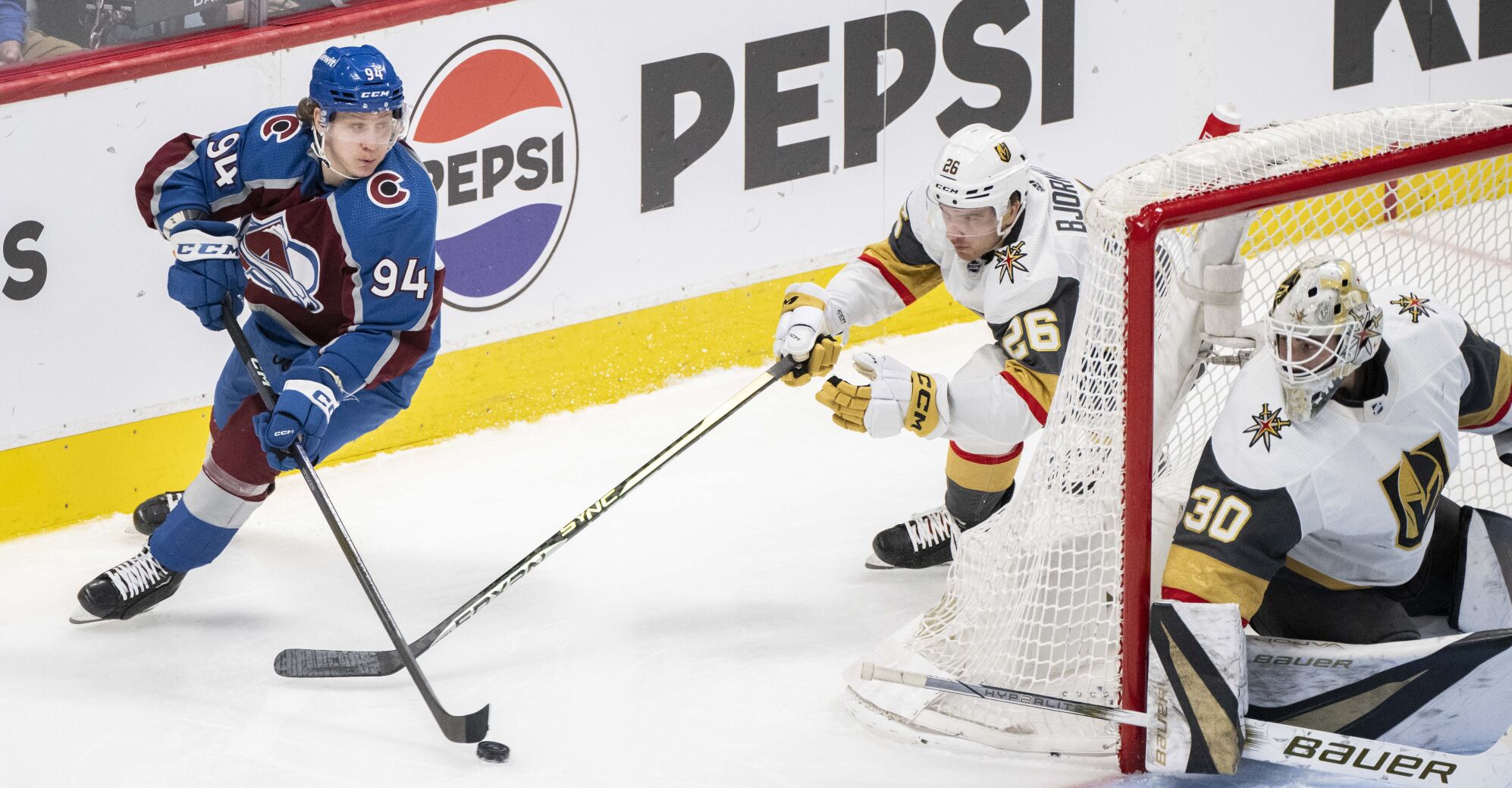 Colorado Avalanche left wing Joel Kiviranta (94) moves the puck behind the Vegas Golden Knights goal as Vegas Golden Knights goaltender Jiri Patera (30) defends during the third period Wednesday, Jan. 10, 2024, at Ball Arena in Denver. (The Gazette, Christian Murdock) (Christian Murdock/The Gazette)