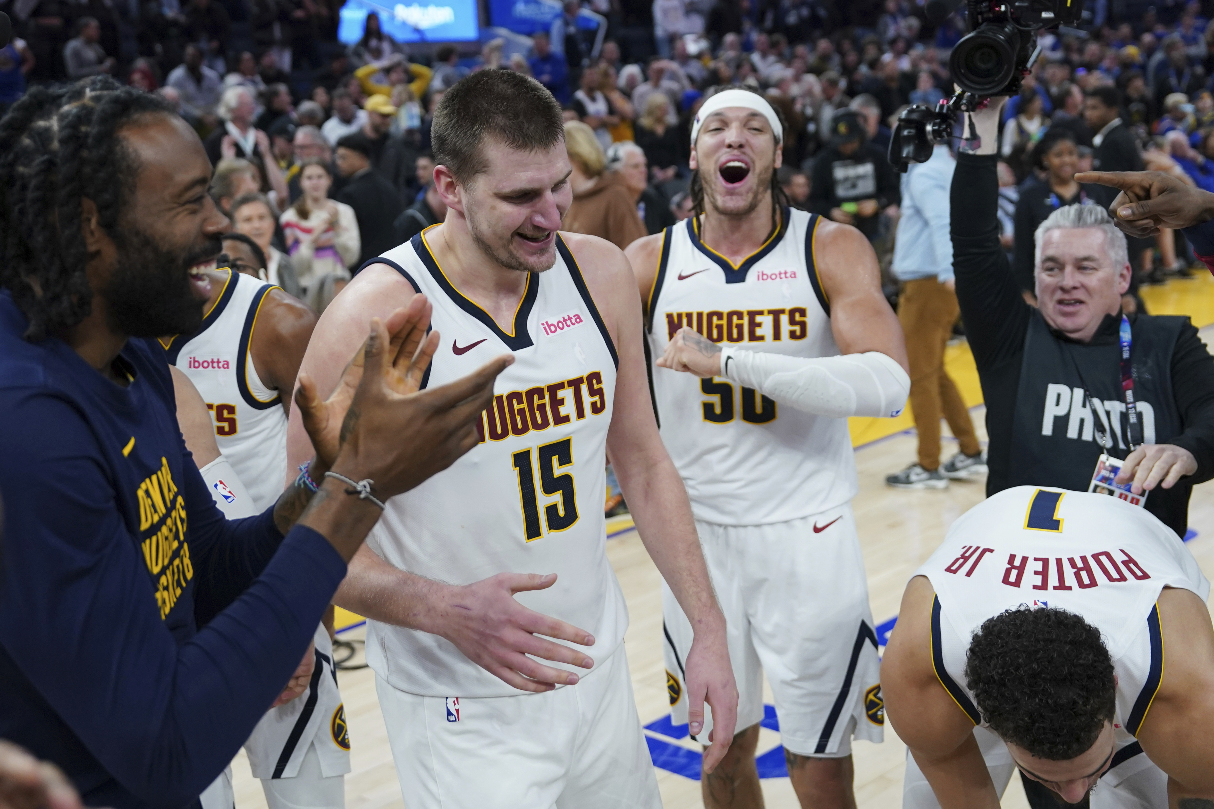 Denver Nuggets center Nikola Jokic (15) celebrates with teammates after his 3-pointer against the Golden State Warriors at the end of an NBA basketball game Thursday, Jan. 4 in San Francisco. (the associated press)