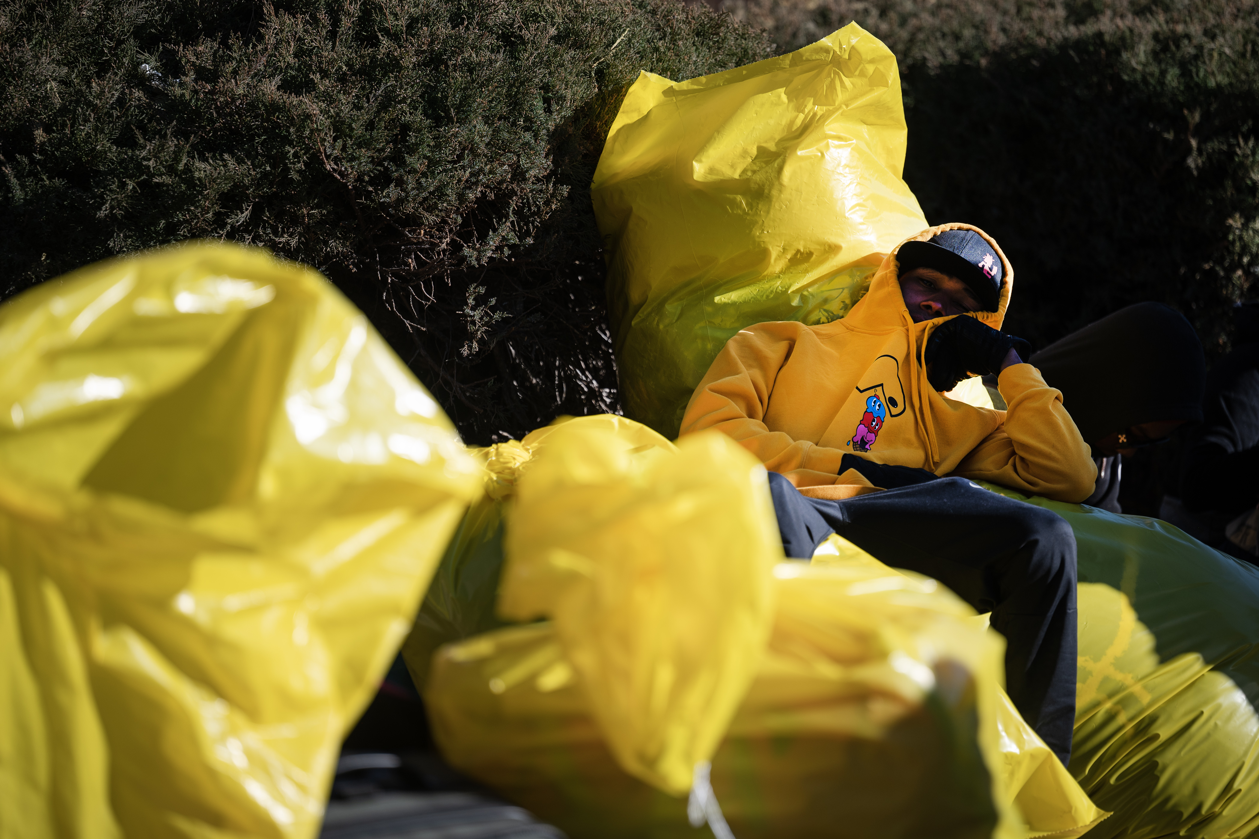 A man lays on piles of bags with his belongings while waiting to be processed and get on a bus during an encampment sweep at West 27th Avenue, between Zuni and Alcott Streets on Wednesday, Jan. 3, 2024, in Denver, Colo. (Timothy Hurst/Denver Gazette) (TimHursttim.hurst@gazette.comhttps://secure.gravatar.com/avatar/aca82bd62b4ee425c598527cd6faa1b1?d=mm&r=g)