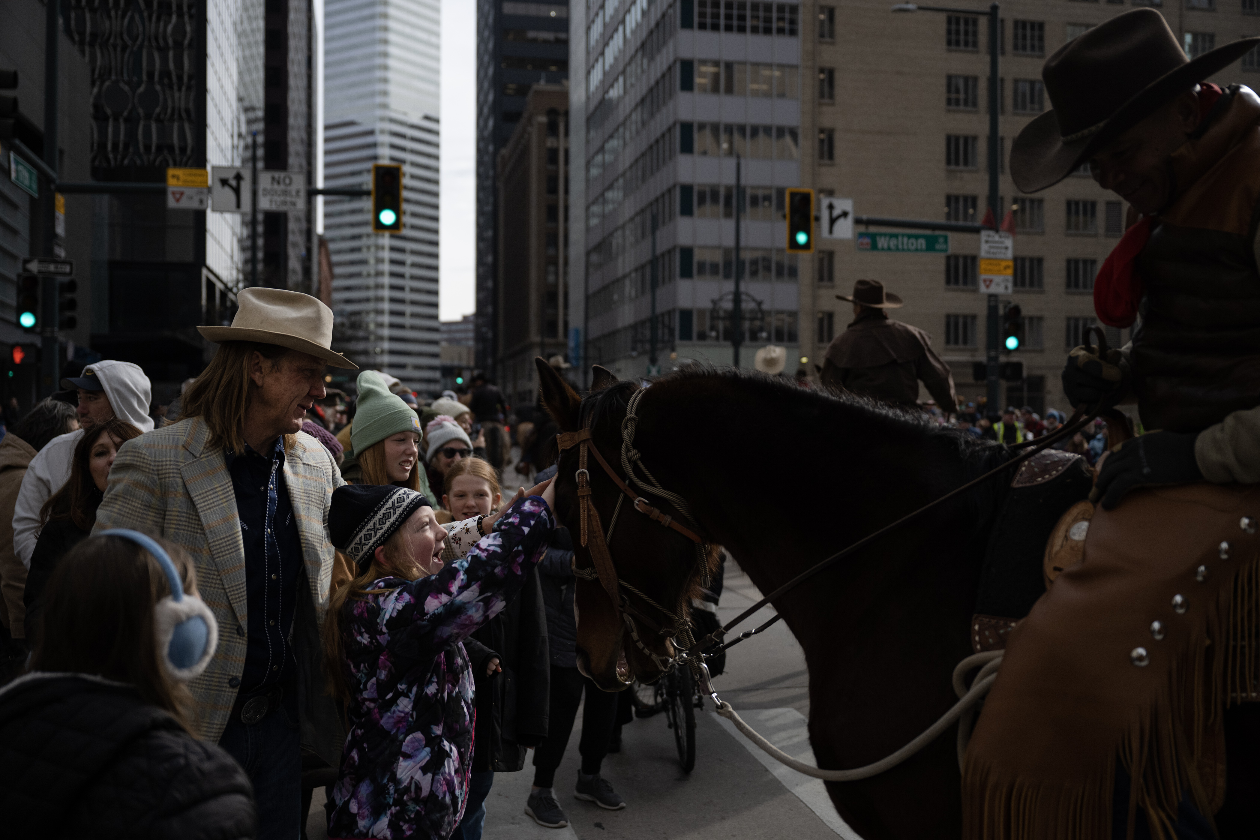 Caroline Mahe, 10, pets a horse during a quick hold-up in the parade during The National Western Stock Show Kick-off Parade on Thursday, Jan. 4, 2024, in Denver, Colo. (Timothy Hurst/Denver Gazette) (TimHursttim.hurst@gazette.comhttps://secure.gravatar.com/avatar/aca82bd62b4ee425c598527cd6faa1b1?d=mm&r=g)