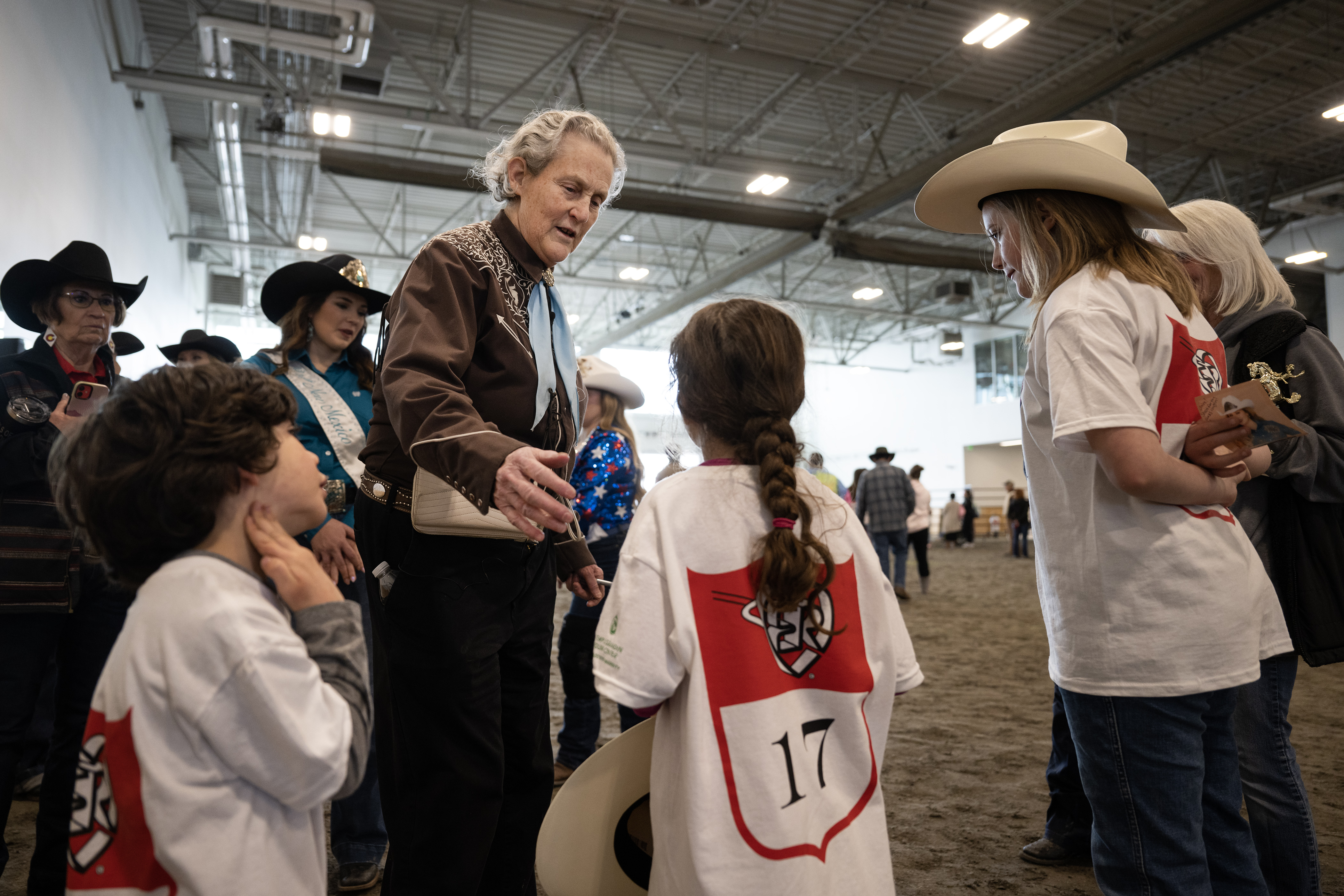 Temple Grandin greets rodeo participants, from left, brother and sister Leon, 5, and Irie Overland, 6, and their cousin Claire Dickey, 10, before they all had their photo taken together during the annual PRCA Exceptional Rodeo on Thursday, Jan. 18, 2024, at the Temple Grandin Equine Center at Colorado State University Spur in Denver, Colo. (Timothy Hurst/Denver Gazette) (TimHursttim.hurst@gazette.comhttps://secure.gravatar.com/avatar/aca82bd62b4ee425c598527cd6faa1b1?d=mm&r=g)