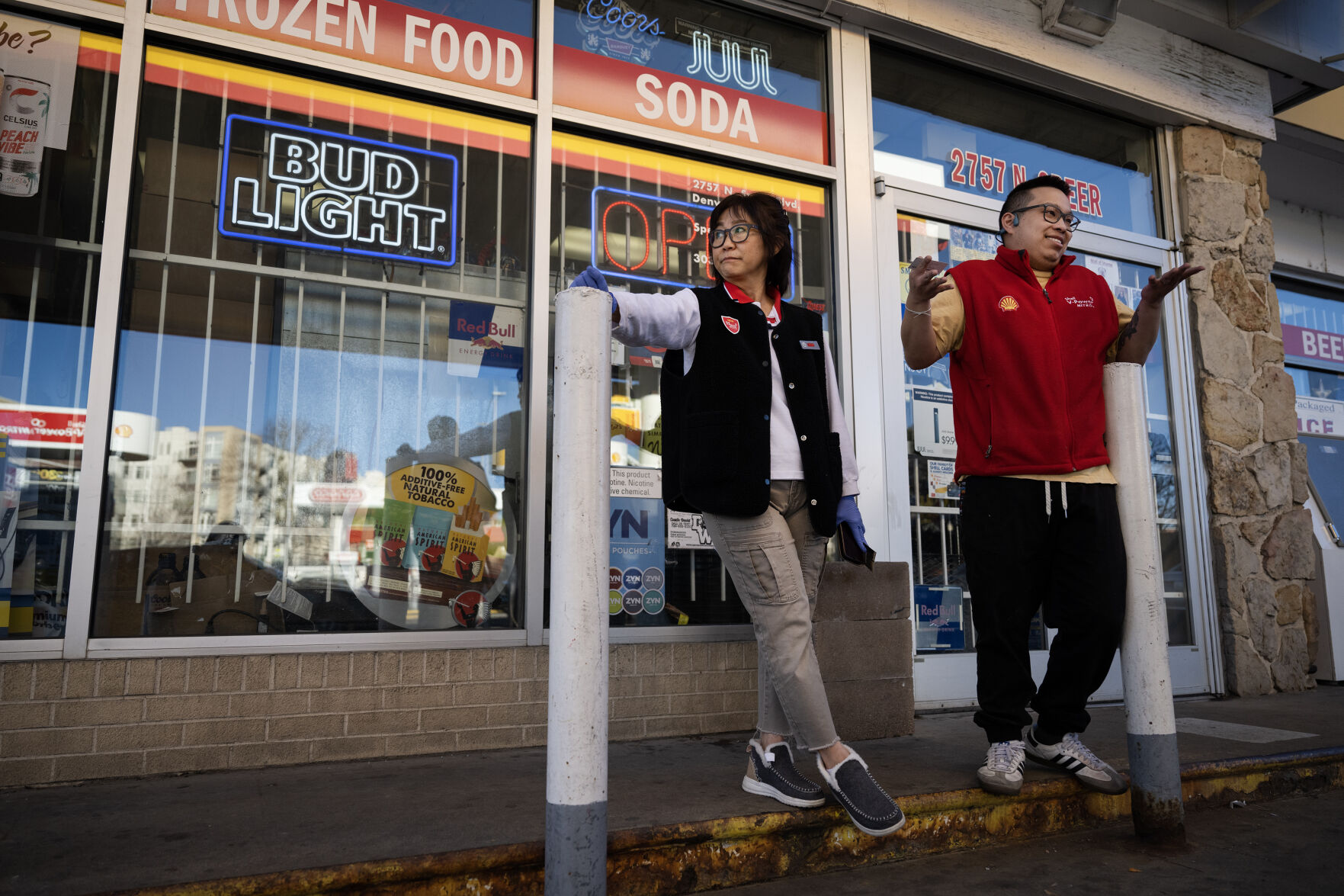 Tip Cordova, the owner of the Shell gas station at North Speer Boulevard and Zuni Street, left, and her son, manager Sam Plumsukon, describe their frustrations over the lost business they’ve been experiencing since migrants from the encampment behind the store have been congregating on the store’s property and deterring potential customers from pulling in, on Friday, Dec. 29, 2023, in Denver, Colo. Plumsukon also talked about the unsafe conditions he’s seen with children playing in the street and parking lot near traffic at the busy intersection. (Timothy Hurst/Denver Gazette) (TimHursttim.hurst@gazette.comhttps://secure.gravatar.com/avatar/aca82bd62b4ee425c598527cd6faa1b1?d=mm&r=g)