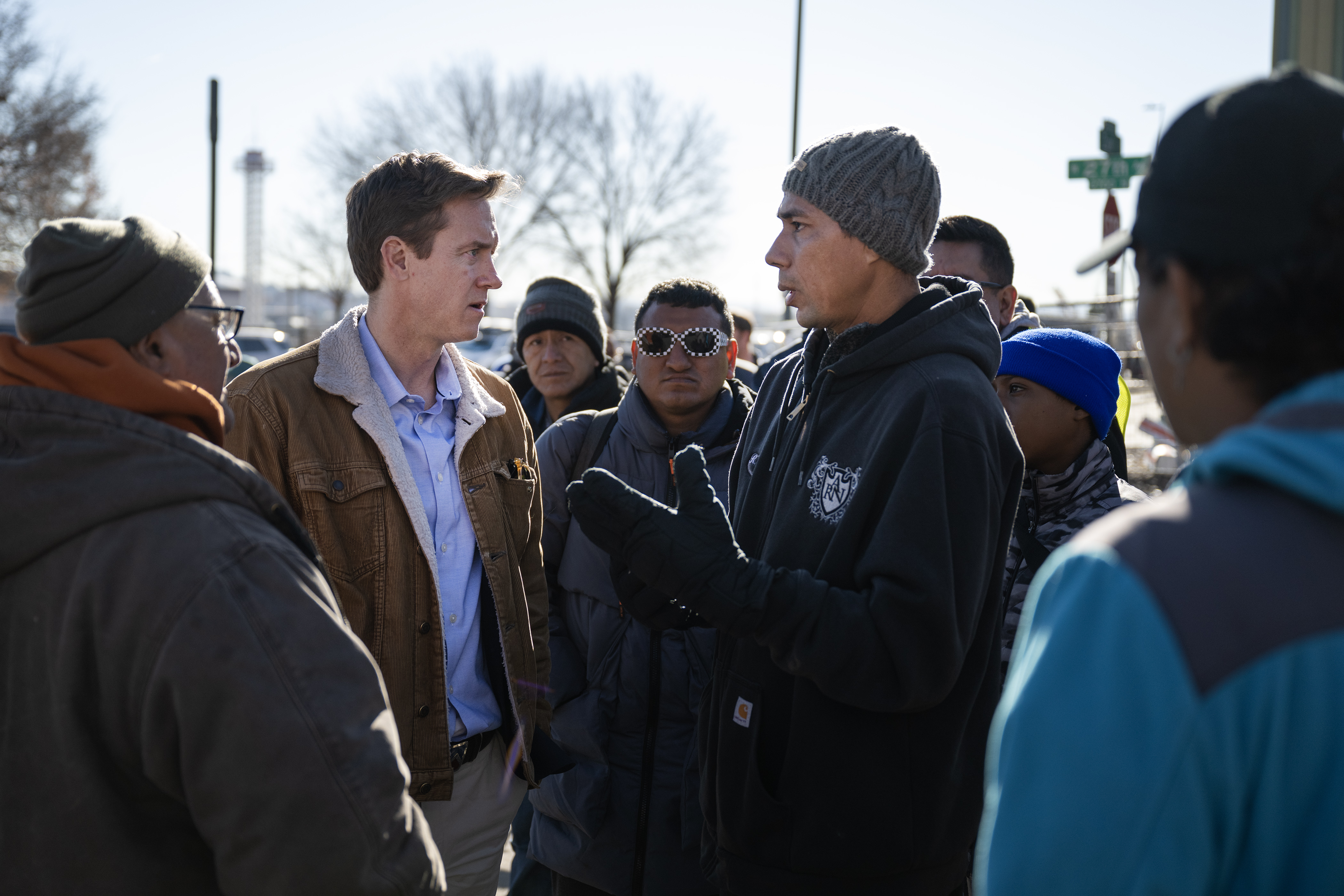Venezuelan Jean Arsenio Vera, center-right, talks with Denver mayor Mike Johnston after Johnston spoke with other immigrants and media during an encampment sweep at West 27th Avenue, between Zuni and Alcott Streets on Wednesday, Jan. 3, 2024, in Denver, Colo. (Timothy Hurst/Denver Gazette) (TimHursttim.hurst@gazette.comhttps://secure.gravatar.com/avatar/aca82bd62b4ee425c598527cd6faa1b1?d=mm&r=g)