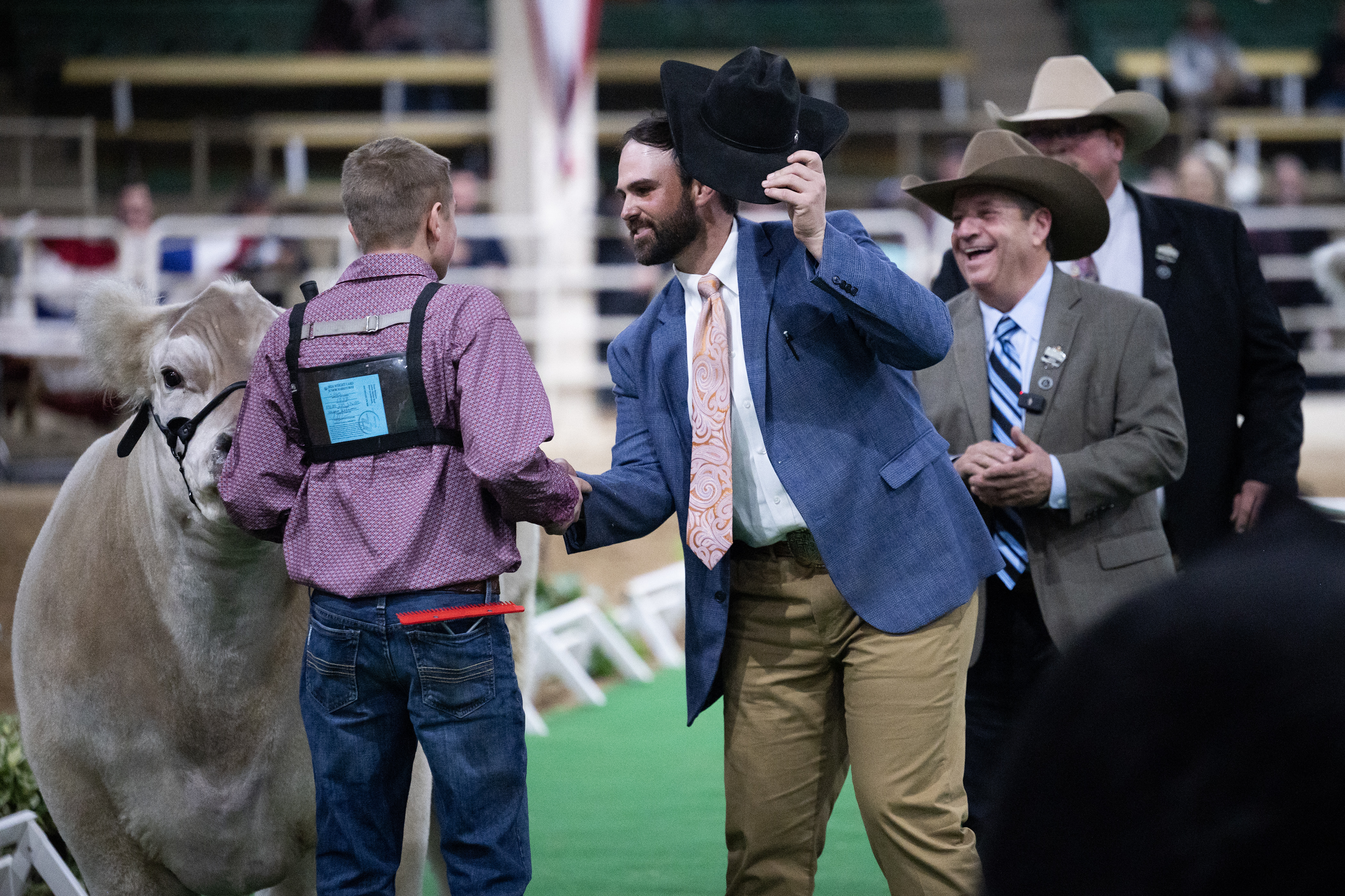 Judge Dustin Frank congratulates Croix Reimann for winning Grand Champion at the Junior Market Steer Grand Drive on Wednesday, Jan. 17, 2024, at the Stadium Arena in the National Western Complex in Denver, Colo.(Timothy Hurst/Denver Gazette) (TimHursttim.hurst@gazette.comhttps://secure.gravatar.com/avatar/aca82bd62b4ee425c598527cd6faa1b1?d=mm&r=g)