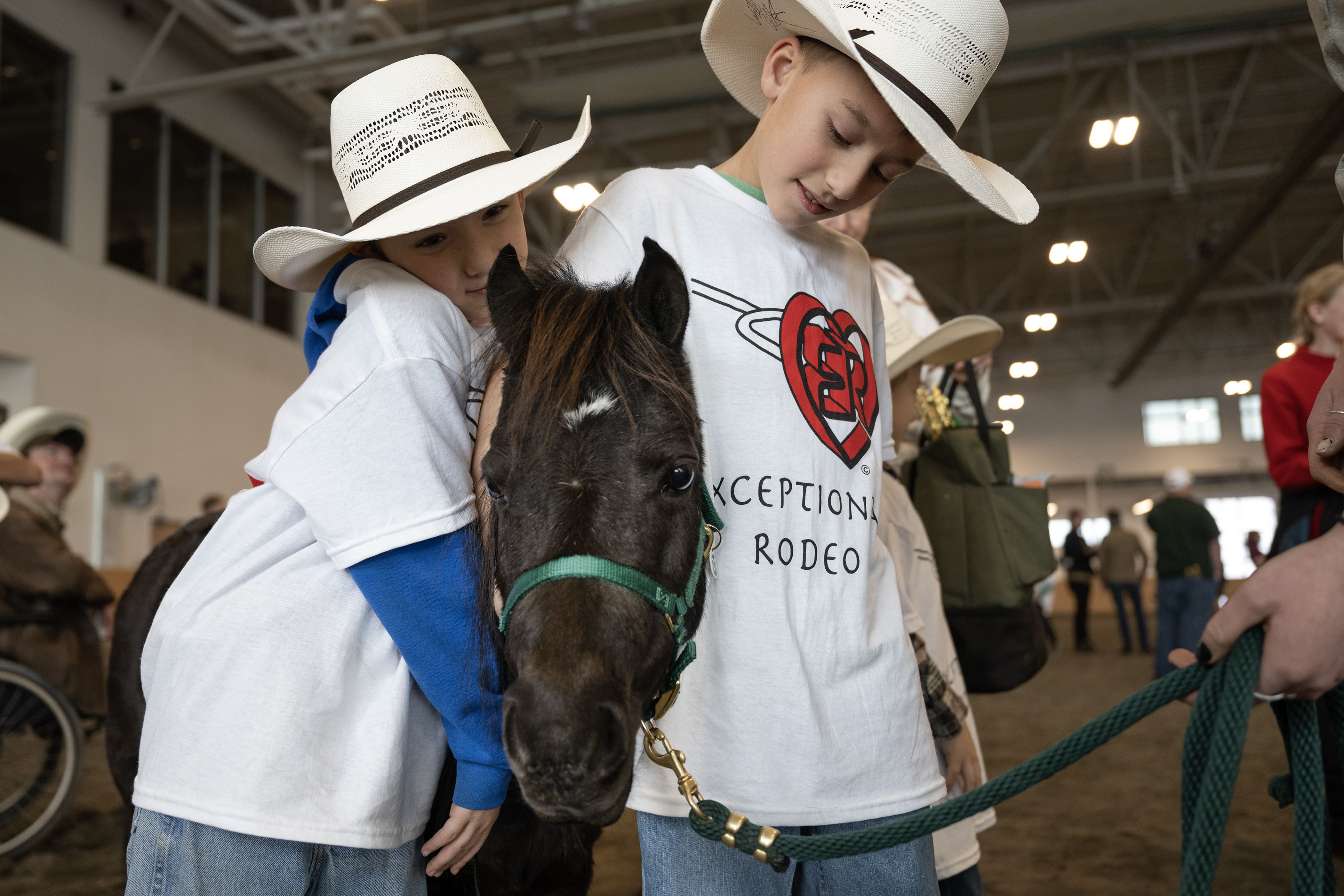 Brothers, from left, Austin James, 8, and Brody Zentner, 10, hugs therapy miniature horse Jewel during the annual PRCA Exceptional Rodeo on Thursday, Jan. 18, 2024, at the Temple Grandin Equine Center at Colorado State University Spur in Denver, Colo. (Timothy Hurst/Denver Gazette) (TimHursttim.hurst@gazette.comhttps://secure.gravatar.com/avatar/aca82bd62b4ee425c598527cd6faa1b1?d=mm&r=g)