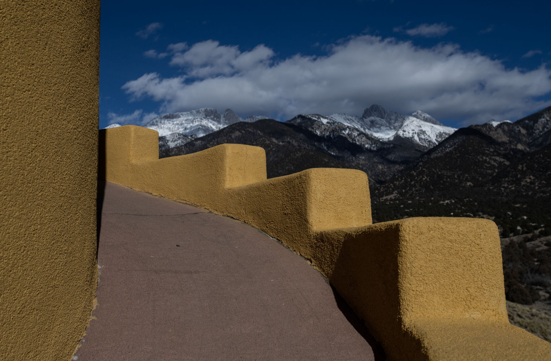 LEFT: The intention of a ziggurat is to bring you closer to the heavens, and as one walks up the Crestone ziggurat’s steep concrete path, the Sangre de Cristo Range and the sand dunes can be see from different sides of the monument. (Parker Seibold)