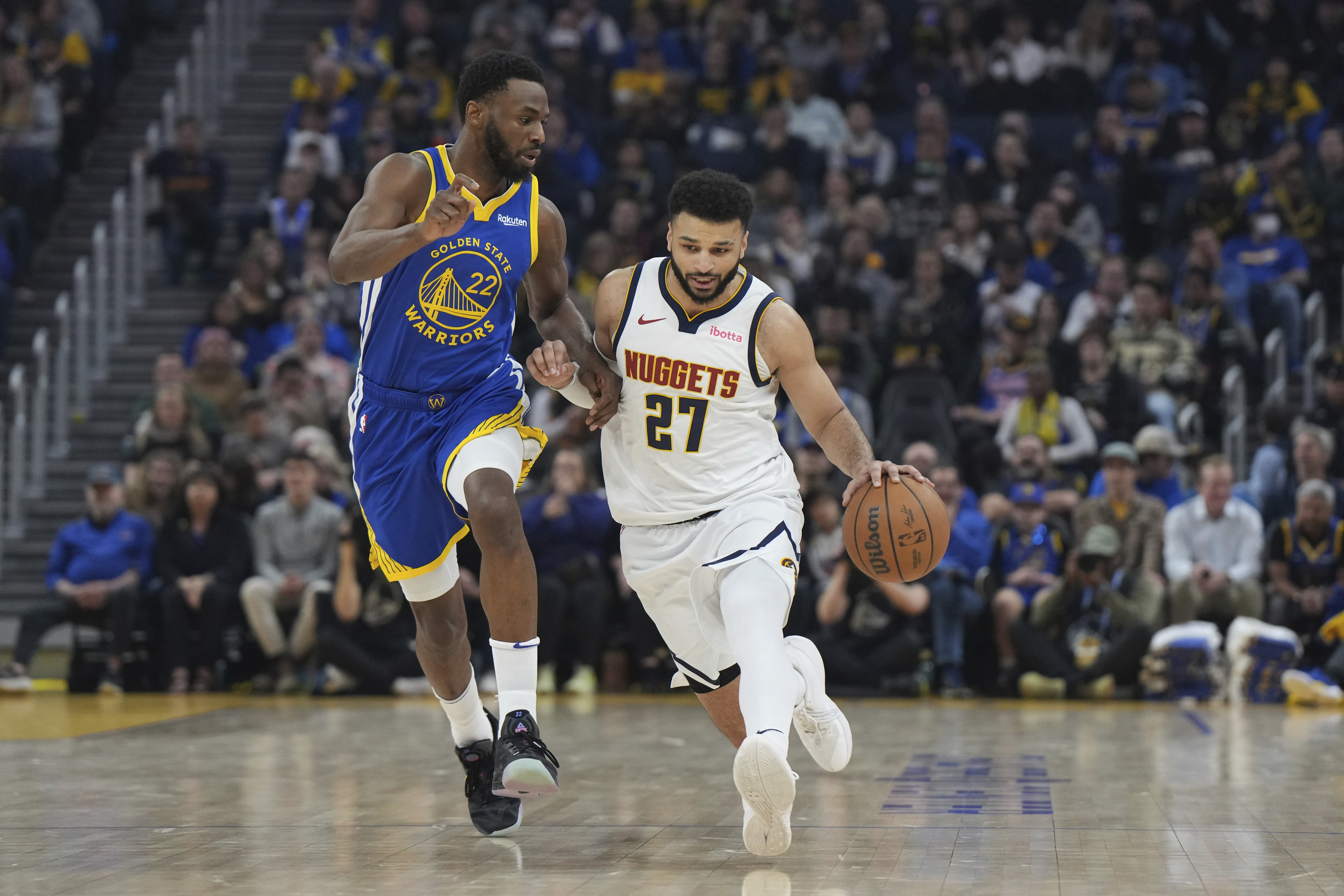 Denver Nuggets guard Jamal Murray (27) dribbles as Golden State Warriors forward Andrew Wiggins (22) defends Thursday, Jan. 4 in San Francisco. (the associated press)