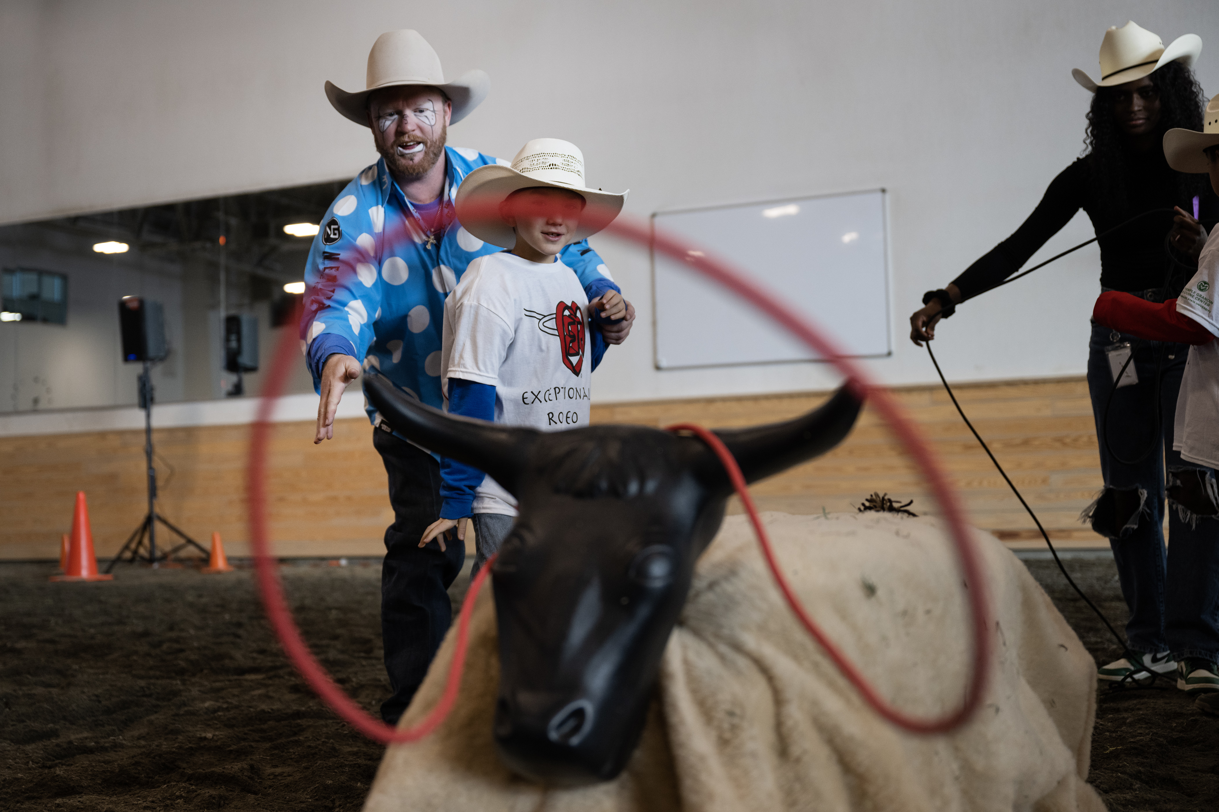 Professional bullfighter Wacey Munsell helps Austin James Zentner, 8, lasso a roping dummy during the annual PRCA Exceptional Rodeo on Thursday, Jan. 18, 2024, at the Temple Grandin Equine Center at Colorado State University Spur in Denver, Colo.(Timothy Hurst/Denver Gazette) (TimHursttim.hurst@gazette.comhttps://secure.gravatar.com/avatar/aca82bd62b4ee425c598527cd6faa1b1?d=mm&r=g)