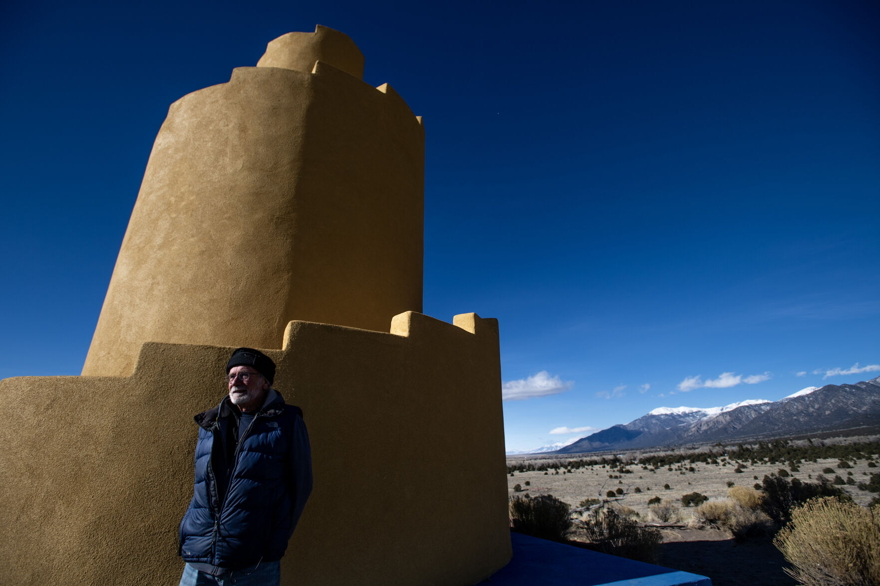 Njal Schold, the director of the Karma Thegsum Tashi Gomang executive committee, stands at the base of the Crestone ziggurat. The Karma Thegsum Tashi Gomang bought the property that contained the ziggurat for only $10 and has been caring for it since 2001. (Parker Seibold)