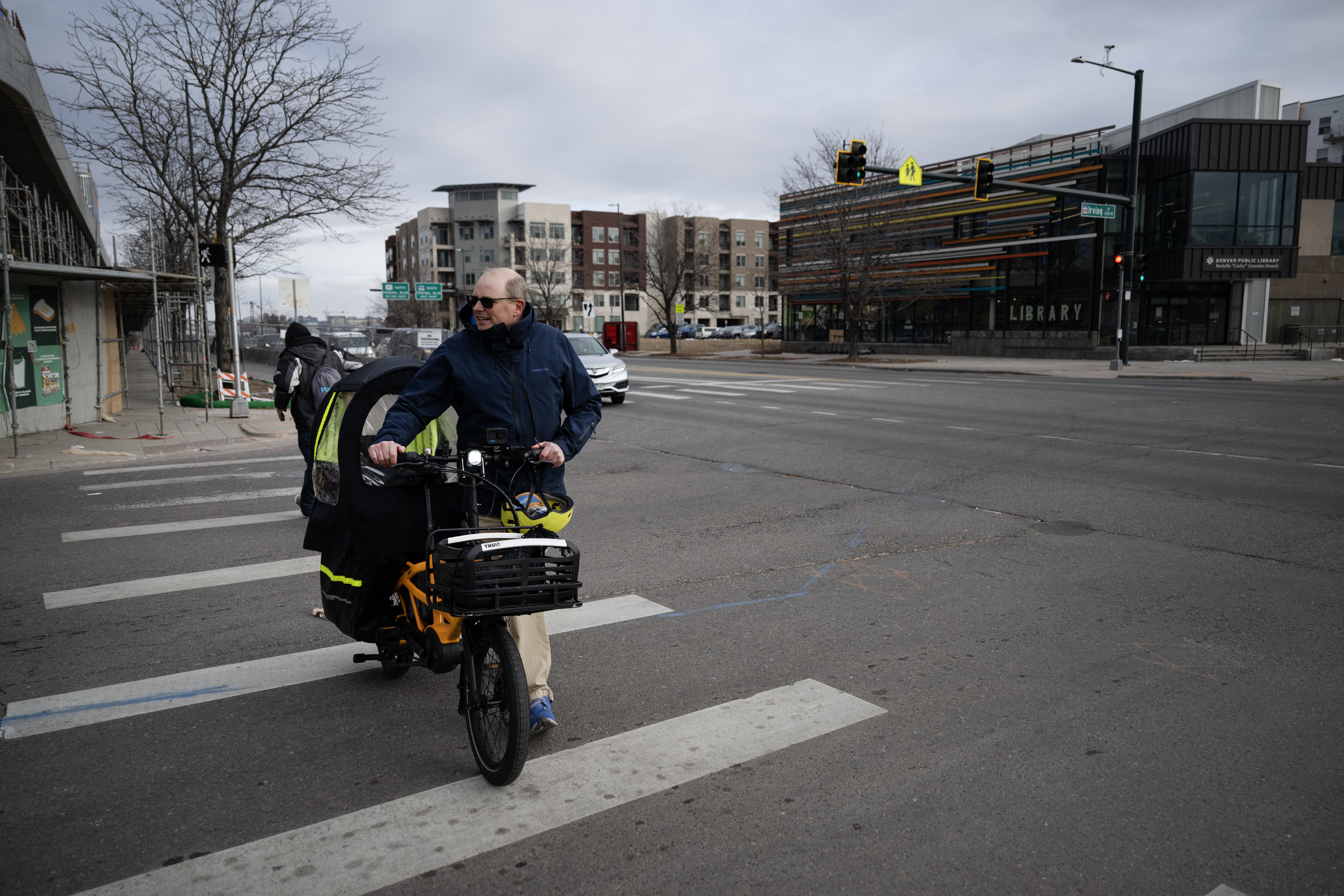 Denver Department of Transportation and Infrastructure Advisory Board co-chair Allen Cowgill walks his bike across Irving Street where it intersects with West Colfax Avenue, the same intersection that his friend Tim Campbell was hit and killed in September of 2020, on Thursday, Jan. 11, 2024, in Denver, Colo. (Timothy Hurst/Denver Gazette) (TimHursttim.hurst@gazette.comhttps://secure.gravatar.com/avatar/aca82bd62b4ee425c598527cd6faa1b1?d=mm&r=g)