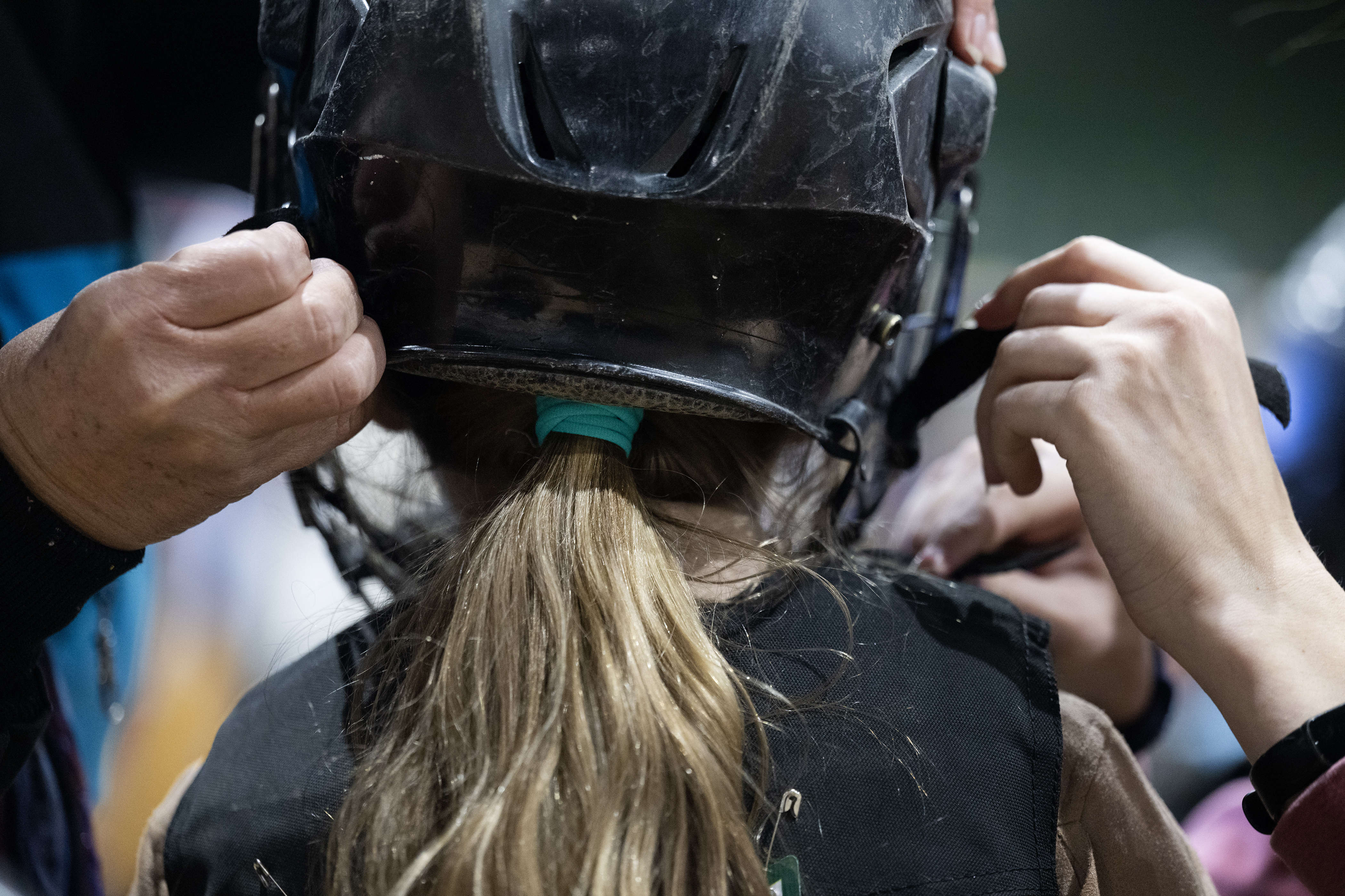Lauren Berkley, 7, has her helmet strapped on before competing in the Stadium Arena Mutton Bustin’ event on Monday, Jan. 8, 2024, at the National Western Complex in Denver, Colo. (Timothy Hurst/Denver Gazette) (TimHursttim.hurst@gazette.comhttps://secure.gravatar.com/avatar/aca82bd62b4ee425c598527cd6faa1b1?d=mm&r=g)
