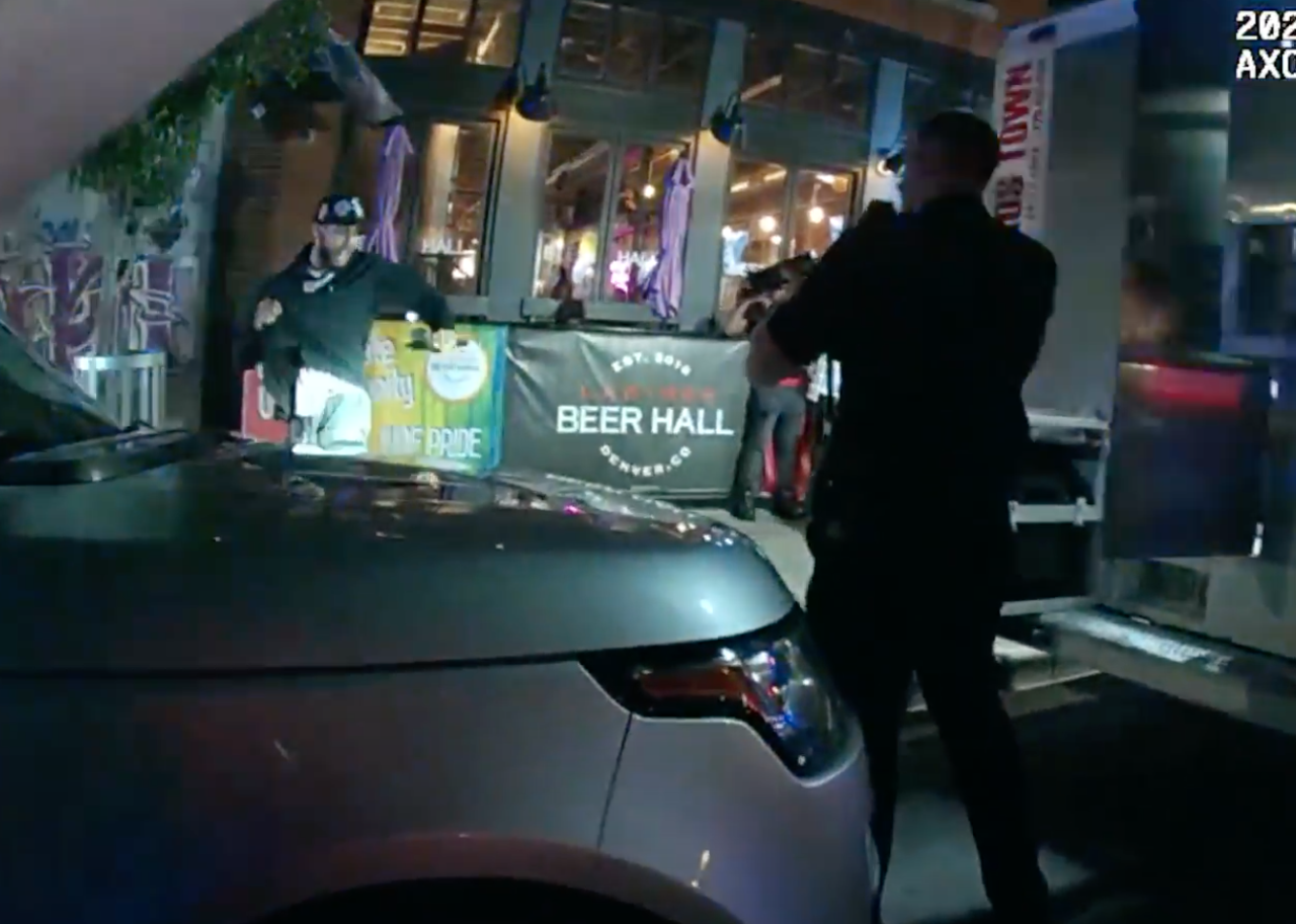FILE PHOTO: Screen grab of body-worn camera footage showing Jordan Waddy with a gun, apparently starting to throw it. (DENVER POLICE DEPATMENT)