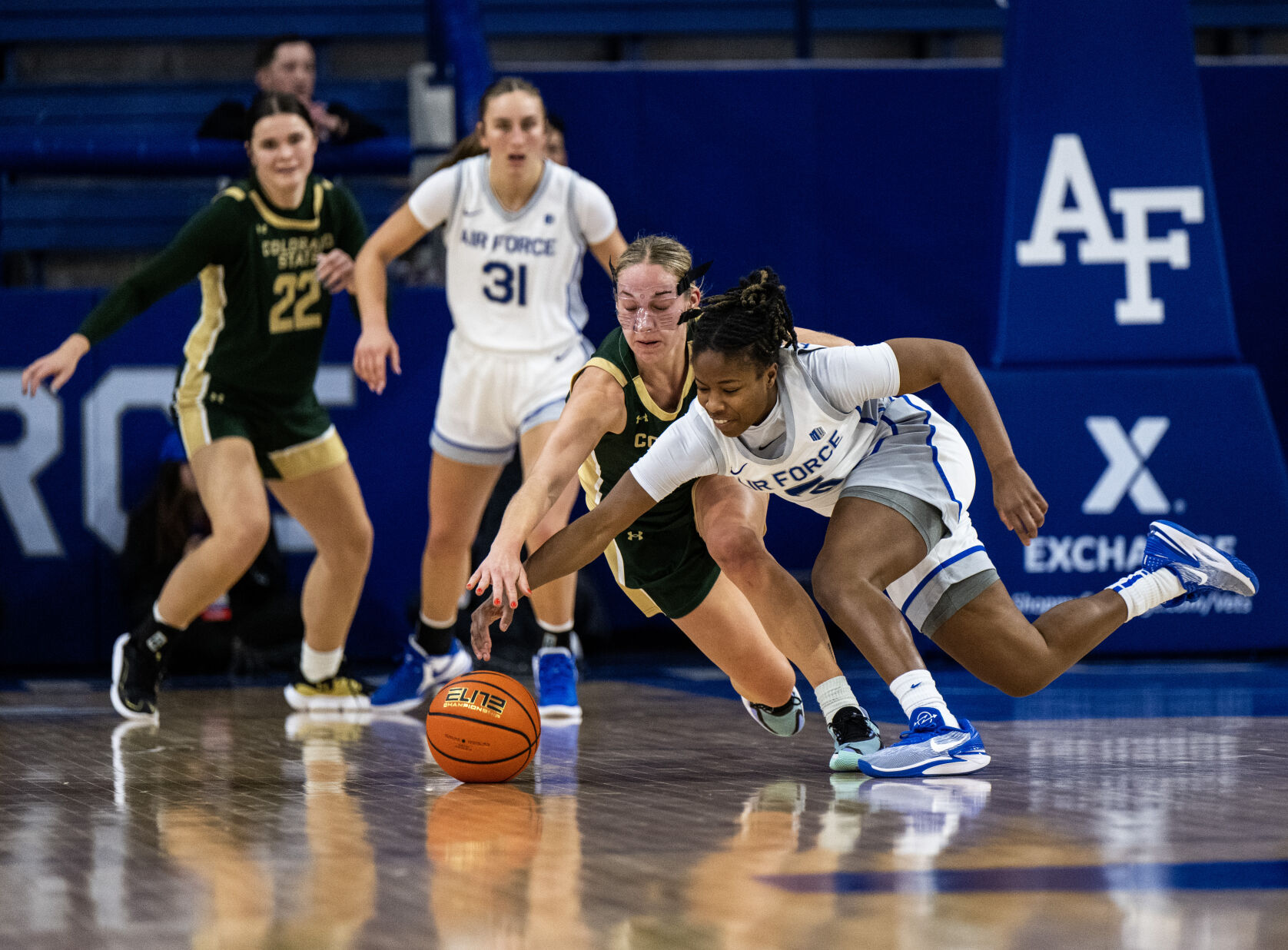 Air Force guard Taylor Britt (4) and Colorado State University guard Hannah Ronsiek (30) reach for a loose ball in the second half of a NCAA basketball game on Wednesday, Jan. 31, 2024, at Air Force Academy, Colo. (Parker Seibold, The Gazette) (Parker Seibold)