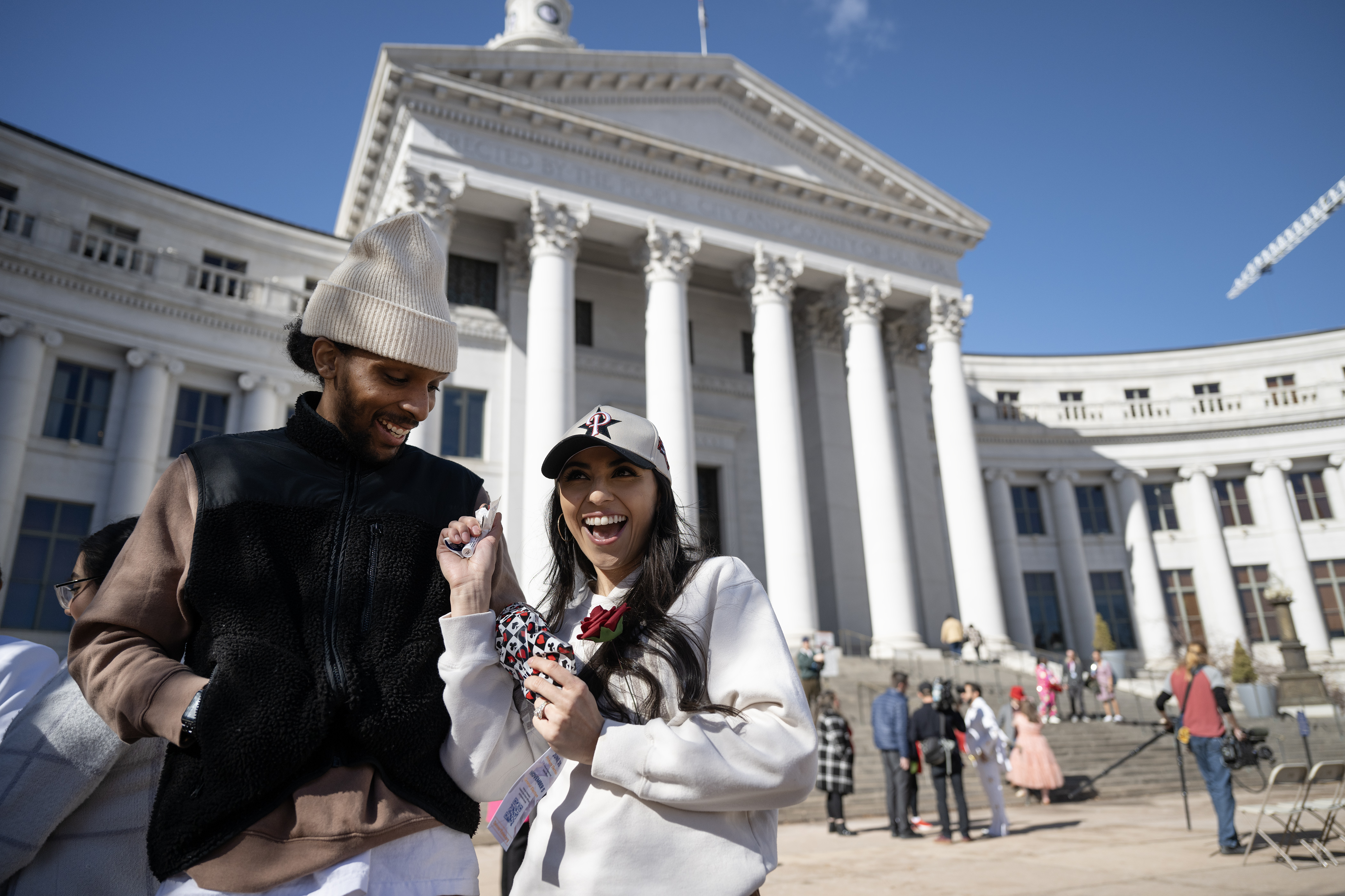 Corrina Coleman, laughs as she finds the lip balm and other assorted trinkets she and her newlywed husband Dakota Coleman received in a gift bag after their wedding outside the Denver City and County Building during the 16th annual Marriage Marathon on Wednesday, Feb. 14, 2024, in Denver, Colo. (Timothy Hurst/Denver Gazette) (TimHursttim.hurst@gazette.comhttps://secure.gravatar.com/avatar/aca82bd62b4ee425c598527cd6faa1b1?d=mm&r=g)