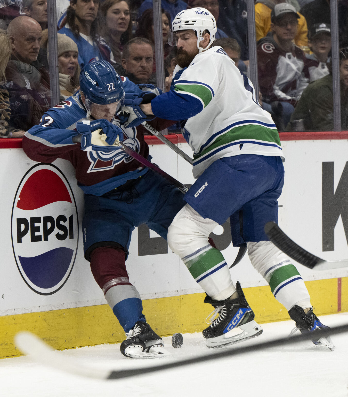 Vancouver Canucks defenseman Filip Hronek (17) checks Colorado Avalanche left wing Fredrik Olofsson (22) into the boards during the first period Tuesday, Feb. 20, 2024, at Ball Arena in Denver. (The Gazette, Christian Murdock) (Christian Murdock/The Gazette)