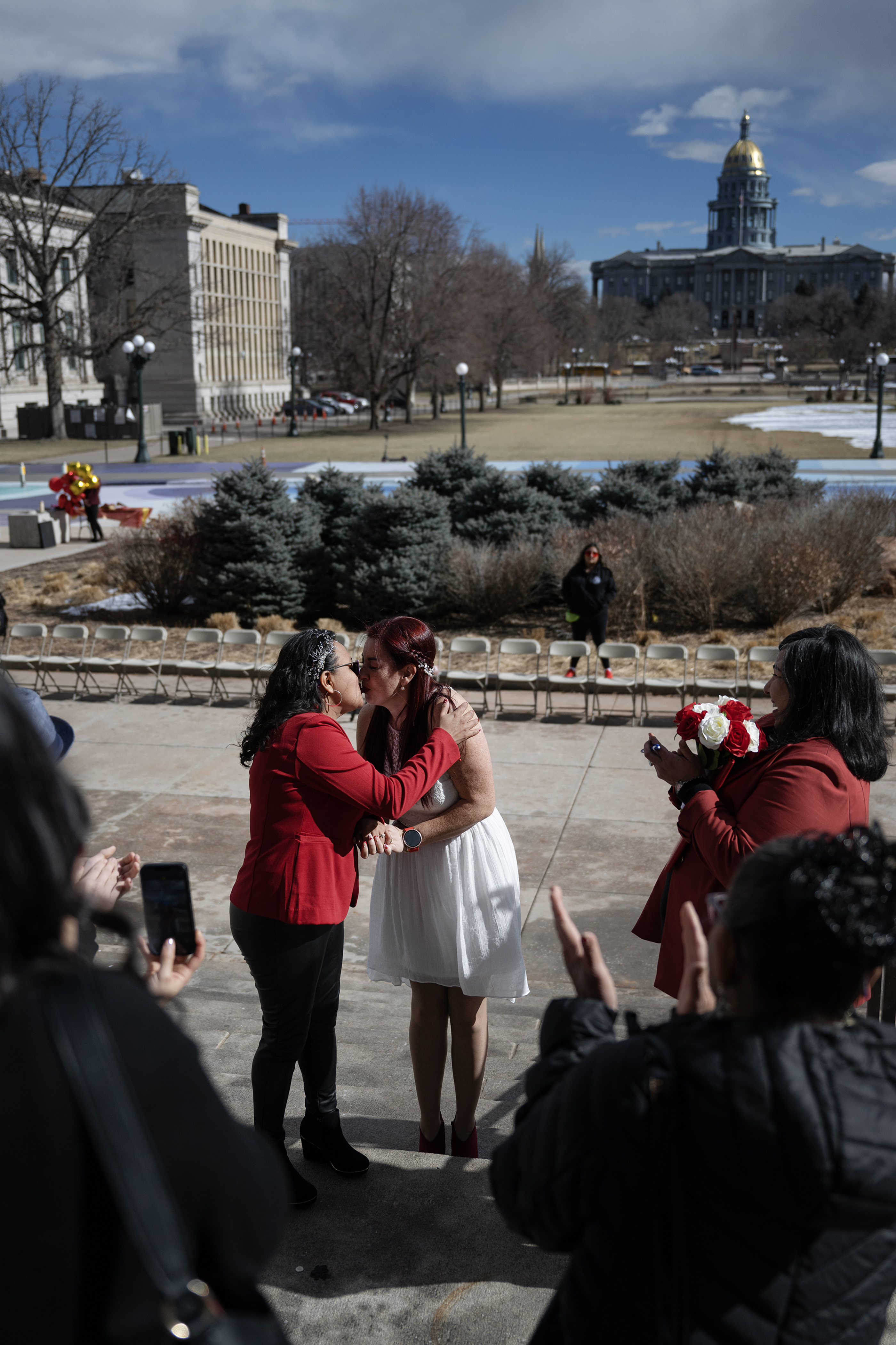Newlyweds Maricendi Jaimes, left, and Mary Reyes share their first kiss as a married couple to conclude their wedding ceremony officiated by their friend and Denver City Councilwoman Jamie Torres, right, on the steps of the Denver City and County Building during the 16th annual Marriage Marathon on Wednesday, Feb. 14, 2024, in Denver, Colo. (Timothy Hurst/Denver Gazette) (TimHursttim.hurst@gazette.comhttps://secure.gravatar.com/avatar/aca82bd62b4ee425c598527cd6faa1b1?d=mm&r=g)