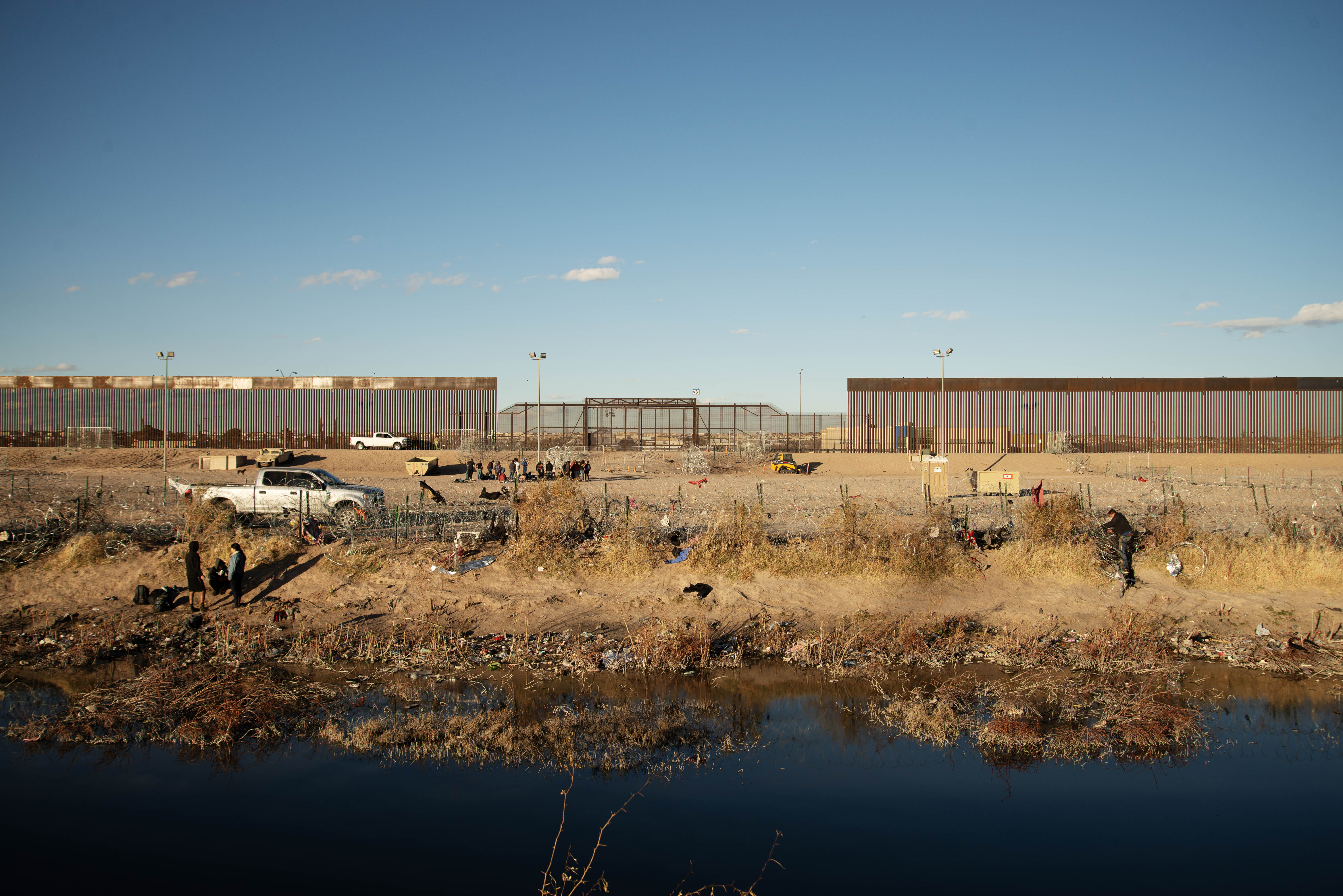 Immigrants look for ways to cross a series of recently-erected barbed wire groupings to enter a processing and staging area on the northern bank of the Rio Grande River between Juarez, Mexico and El Paso, Texas on Thursday, Feb. 1, 2024. (Tom Hellauer, Denver Gazette) (TomHellauerMultimedia Producertom.hellauer@denvergazette.comhttps://denvergazette.com/content/tncms/avatars/f/9e/622/f9e6228a-3b6b-11ed-bf10-fbb71fa8e421.f54b911252c540f1d61709edc4727a39.png)