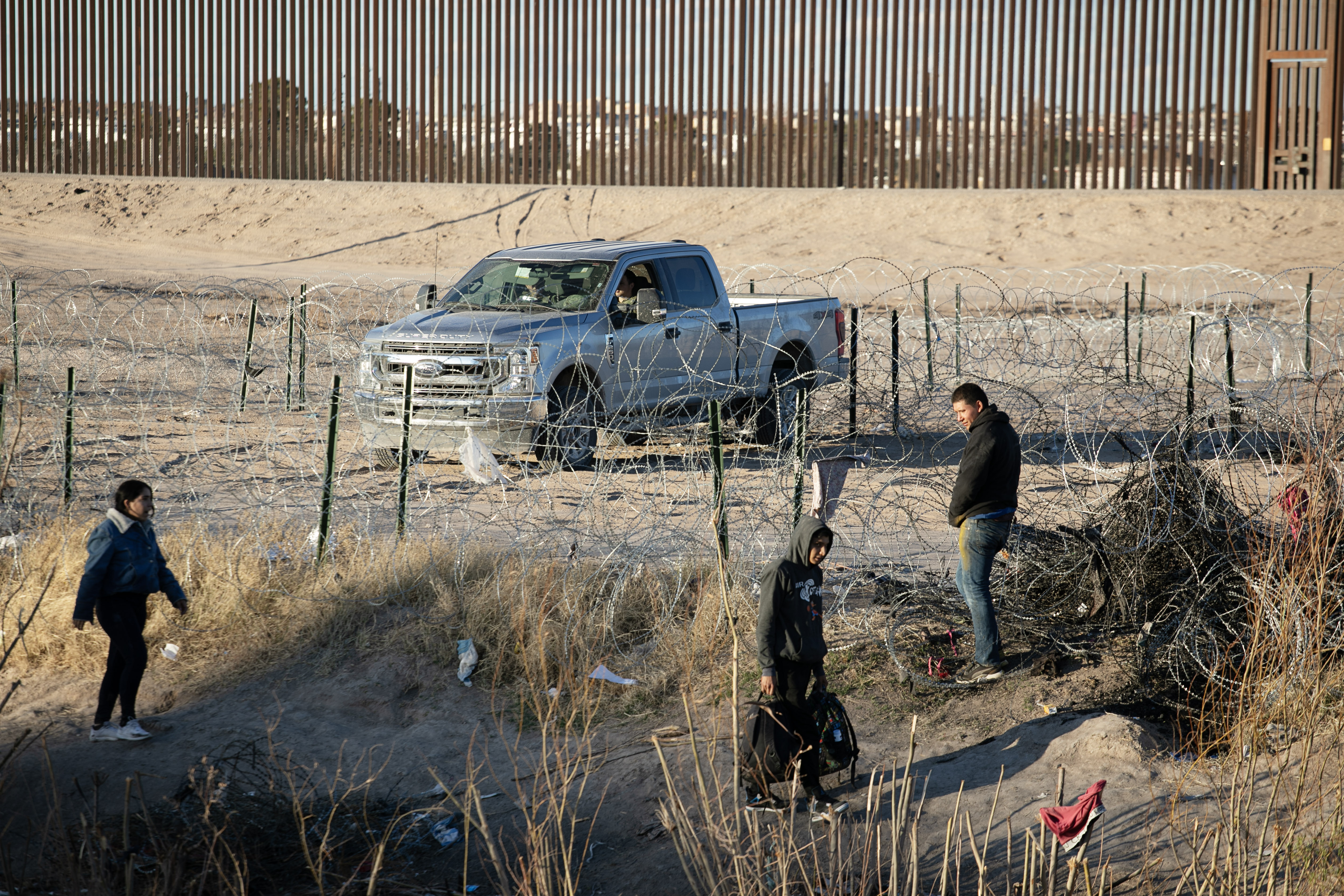 Immigrants probe areas of recently-installed barbed wire while members of the Texas National Guard watch from a truck on the northern bank of the Rio Grande between Juarez, Mexico and El Paso, Texas on Thursday, Feb. 1, 2024. (Tom Hellauer, The Gazette) (TomHellauerMultimedia Producertom.hellauer@denvergazette.comhttps://denvergazette.com/content/tncms/avatars/f/9e/622/f9e6228a-3b6b-11ed-bf10-fbb71fa8e421.f54b911252c540f1d61709edc4727a39.png)