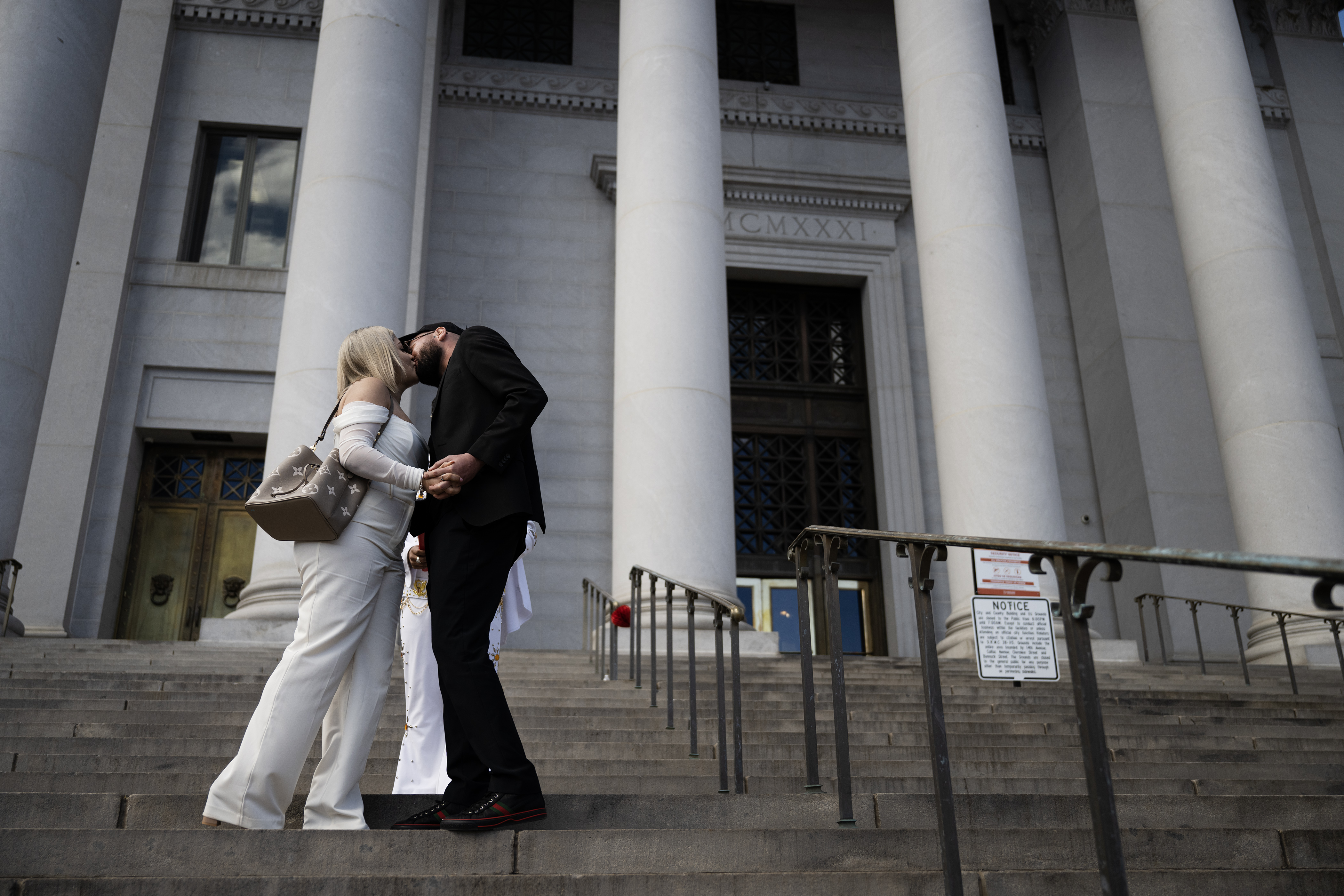 Newlyweds Erika Perez Martinez and Hugo Espinoza Ortiz share their first kiss as a married couple on the steps of the Denver City and County Building during the 16th annual Marriage Marathon on Wednesday, Feb. 14, 2024, in Denver, Colo. (Timothy Hurst/Denver Gazette) (TimHursttim.hurst@gazette.comhttps://secure.gravatar.com/avatar/aca82bd62b4ee425c598527cd6faa1b1?d=mm&r=g)