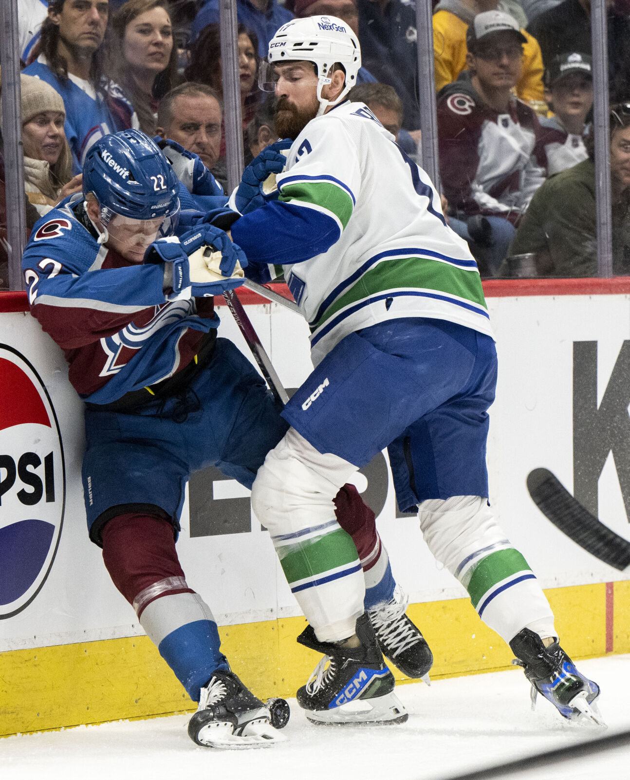 Vancouver Canucks defenseman Filip Hronek (17) checks Colorado Avalanche left wing Fredrik Olofsson (22) into the boards during the first period Tuesday, Feb. 20, 2024, at Ball Arena in Denver. (The Gazette, Christian Murdock) (Christian Murdock/The Gazette)