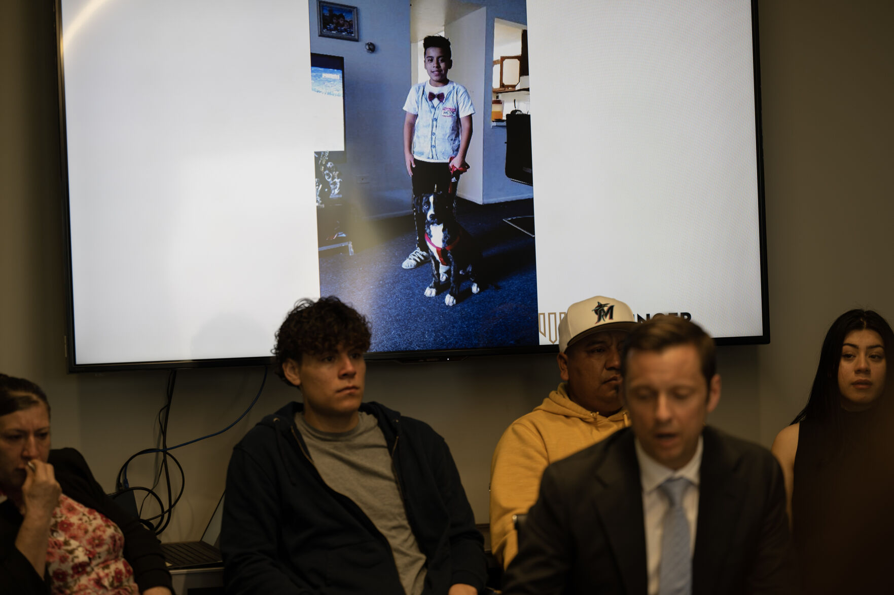 Photos of Luis Garcia, who was shot on February 13th of 2023 in front of East High School and died two weeks later from his injuries, cycle on a screen behind Garcia’s family as the family’s attorney Matthew Barringer speaks to media during a press conference at the Barringer Law Firm office on Tuesday, Feb. 13, 2024, in Greenwood Village, Colo. (Timothy Hurst/Denver Gazette) (TimHursttim.hurst@gazette.comhttps://secure.gravatar.com/avatar/aca82bd62b4ee425c598527cd6faa1b1?d=mm&r=g)