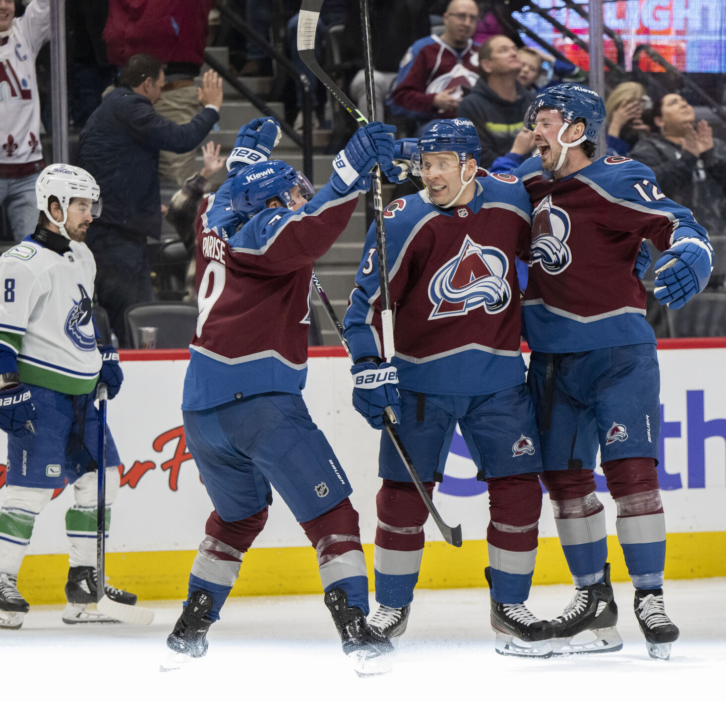Colorado Avalanche center Ryan Johansen (12) celebrates with teammates defenseman Jack Johnson (3) and left wing Zach Parise (9) after scoring his second goal of the game against Vancouver Canucks goaltender Thatcher Demko (35) during the third period Tuesday, Feb. 20, 2024, at Ball Arena in Denver. The Avalanche won 3-1. (The Gazette, Christian Murdock) (Christian Murdock/The Gazette)