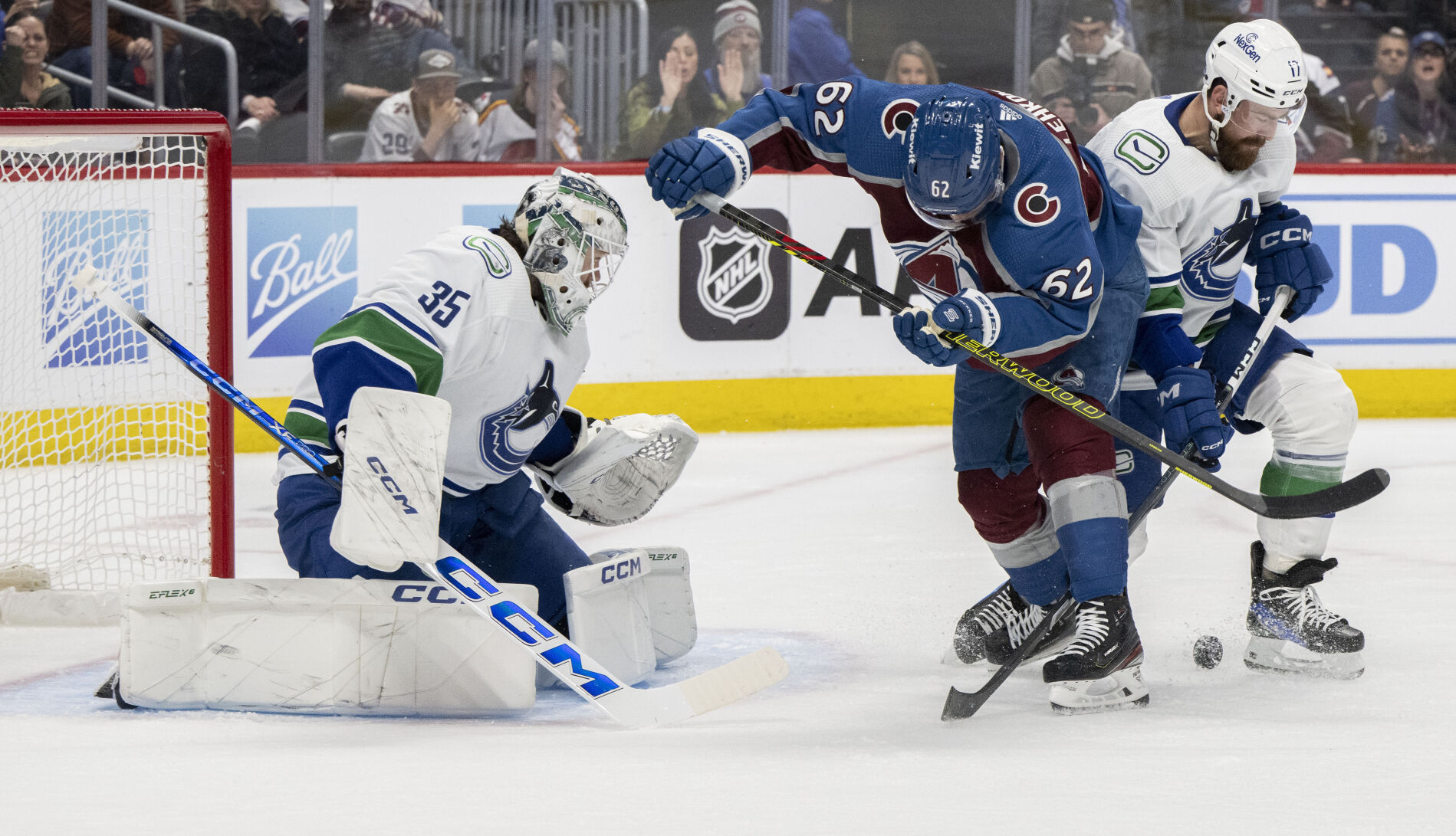 Colorado Avalanche left wing Artturi Lehkonen (62) battles Vancouver Canucks defenseman Filip Hronek (17) for the puck in front of the Vancouver Canucks goal as goaltender Thatcher Demko (35) defends during the first period Tuesday, Feb. 20, 2024, at Ball Arena in Denver. (The Gazette, Christian Murdock) (Christian Murdock/The Gazette)