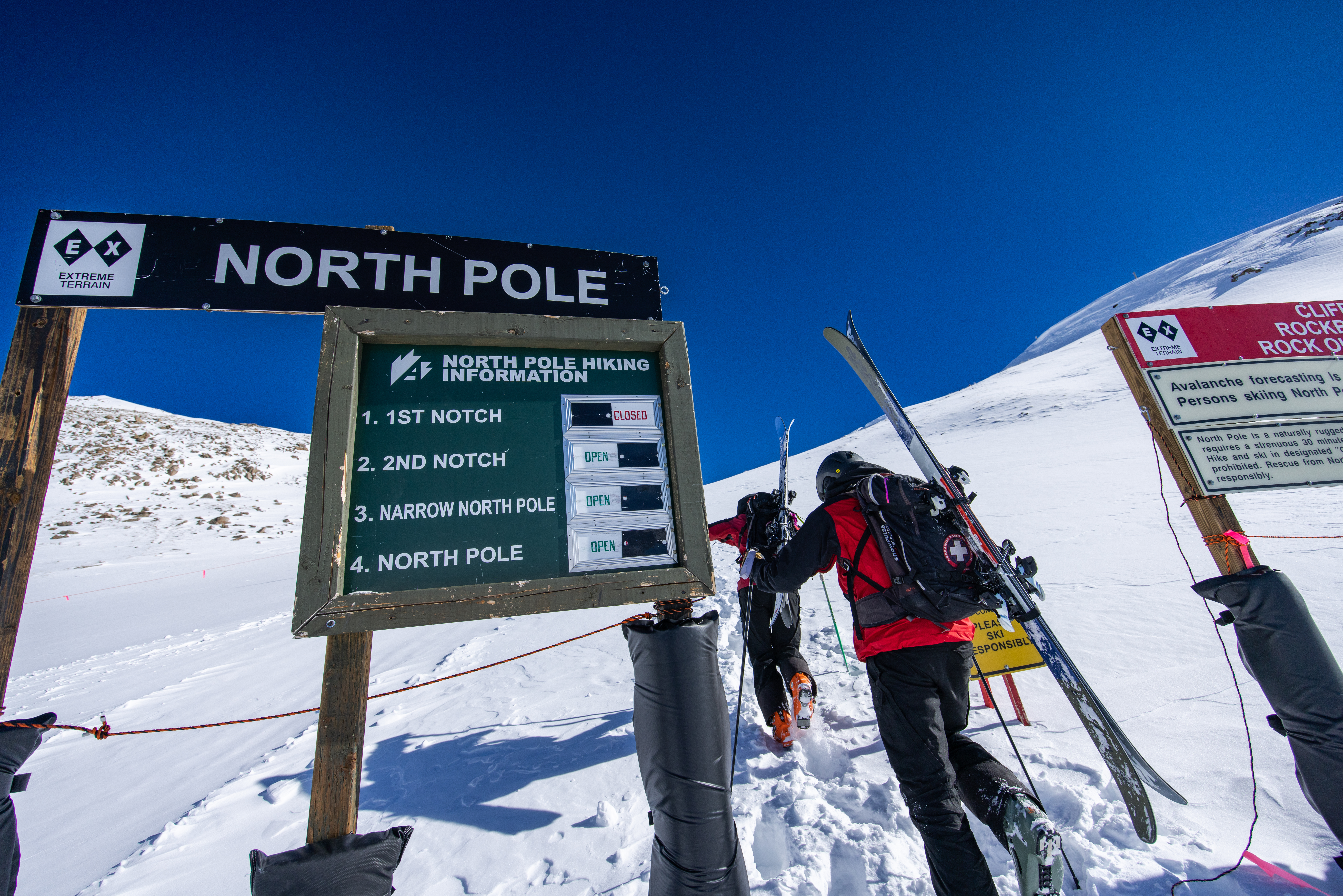 Arapahoe Basin ski patrollers walk passed the North Pole sign of the East Wall sign Friday, Feb. 17, 2023, at Arapahoe Basin Ski Area in Dillon, Colorado. The East Wall is one of the ski areas most famed terrain zone with a history going back 50 plus years. (Ian Zinner, Arapahoe Basin Ski Area)