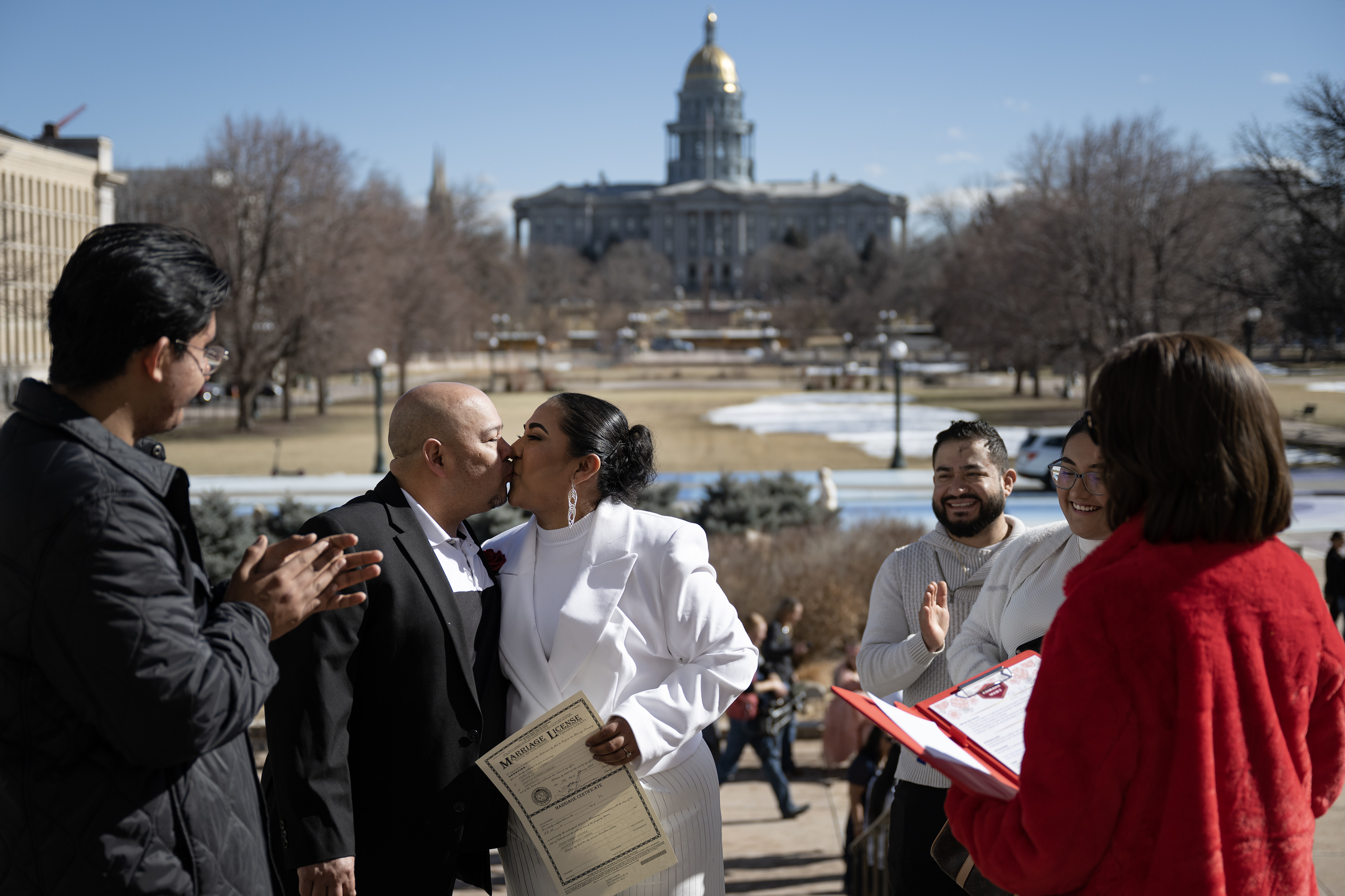 Newlyweds Pedro Torres Guevara and Eudocia Romero Cabrera, who have been together for 20 years, go in for their first kiss as an officially married couple on the steps of the Denver City and County Building during the 16th annual Marriage Marathon on Wednesday, Feb. 14, 2024, in Denver, Colo. (Timothy Hurst/Denver Gazette) (TimHursttim.hurst@gazette.comhttps://secure.gravatar.com/avatar/aca82bd62b4ee425c598527cd6faa1b1?d=mm&r=g)