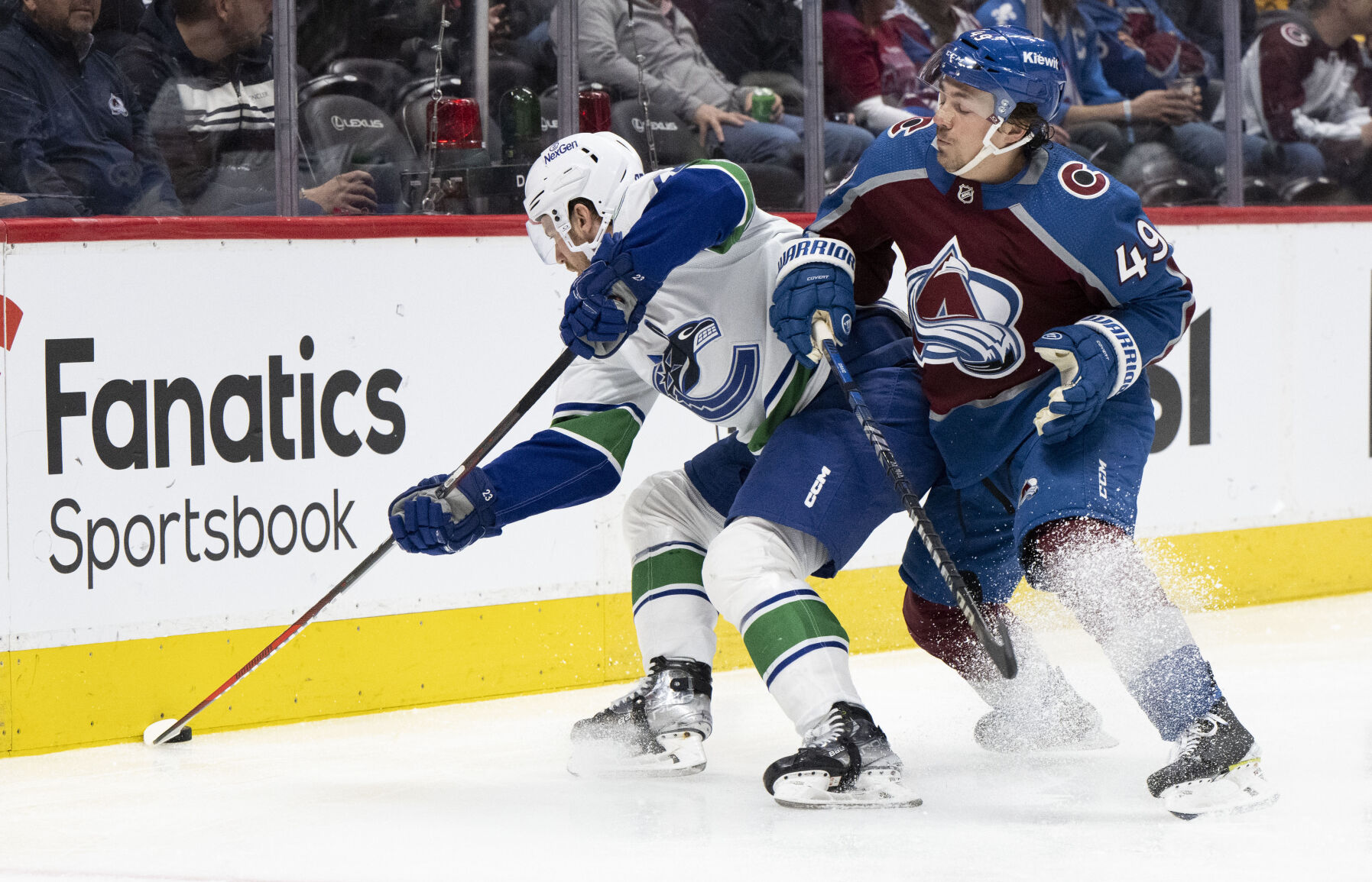 Colorado Avalanche defenseman Samuel Girard (49) defends against Vancouver Canucks center Elias Lindholm (23) during the second period Tuesday, Feb. 20, 2024, at Ball Arena in Denver. (The Gazette, Christian Murdock) (Christian Murdock/The Gazette)