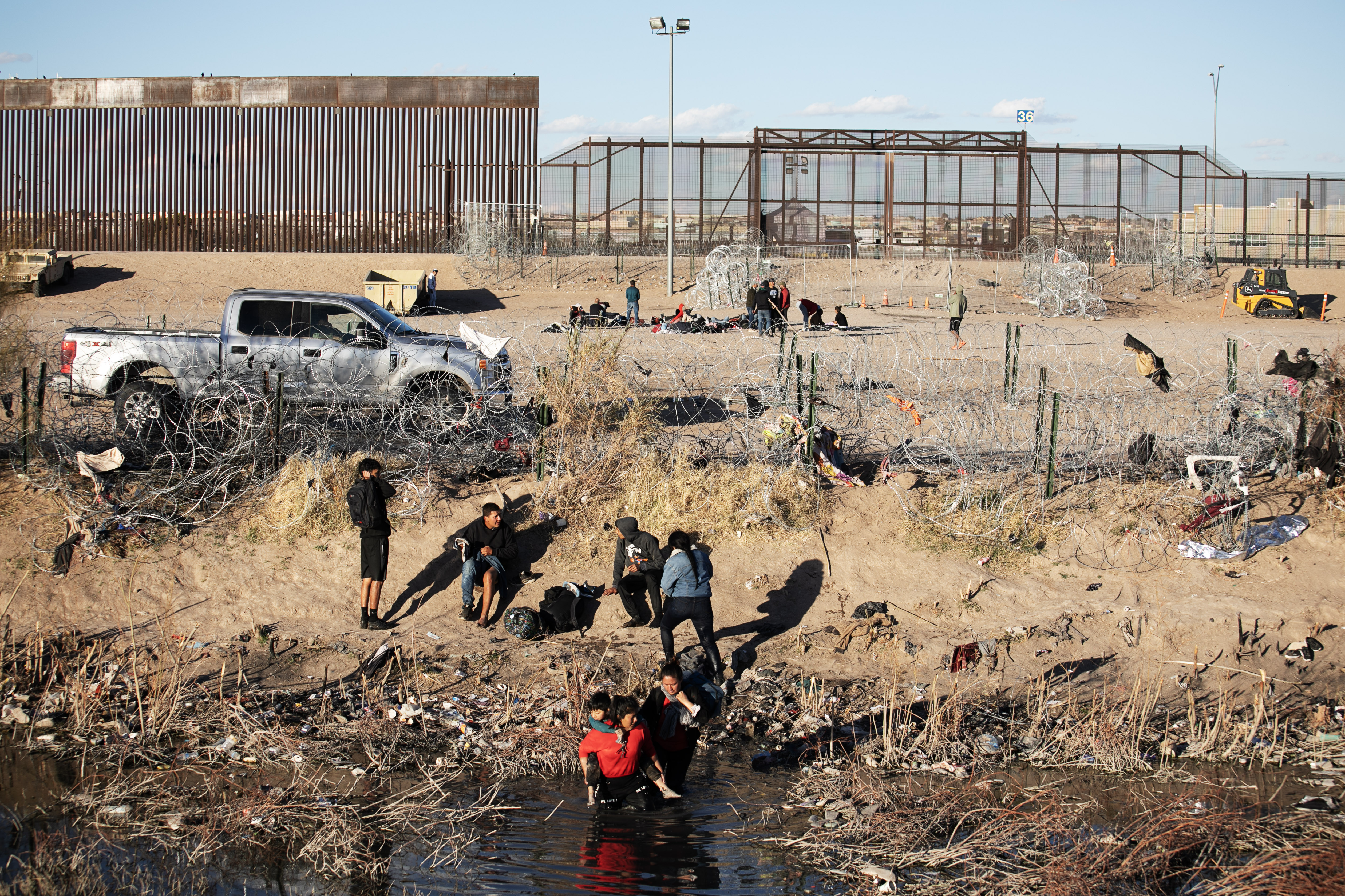 Immigrants probe sections of recently erected barbed wire while a member of the Texas National Guard watches on in a truck between the Juarez and El Paso border on Thursday, Feb. 1, 2024. (Tom Hellauer, The Gazette) (TomHellauerMultimedia Producertom.hellauer@denvergazette.comhttps://denvergazette.com/content/tncms/avatars/f/9e/622/f9e6228a-3b6b-11ed-bf10-fbb71fa8e421.f54b911252c540f1d61709edc4727a39.png)