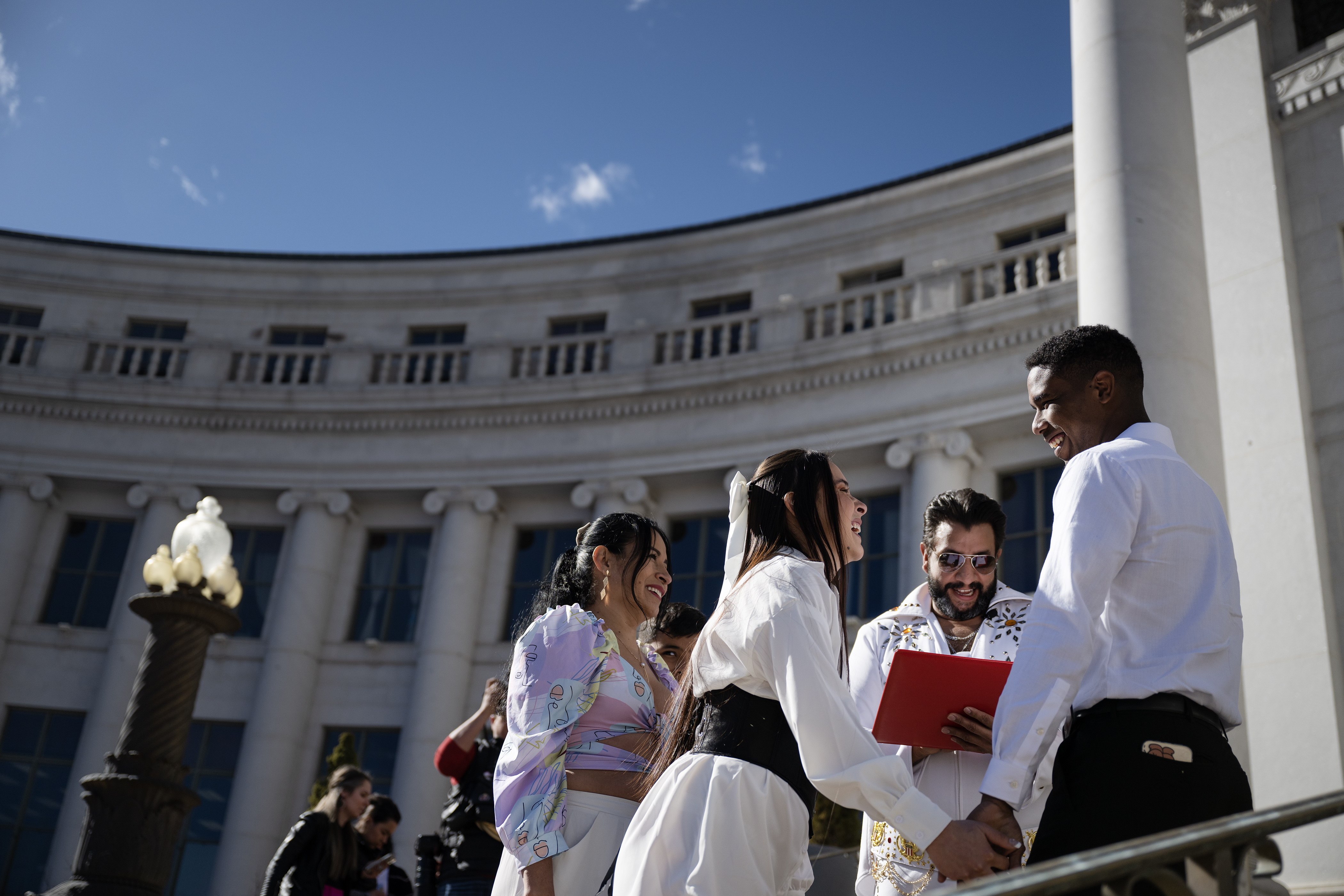 Laura Verjel and Kevin Torres share a laugh while Denver clerk and recorder Paul López, dressed as Elvis Presley for the occasion, officiates their wedding on the steps of the Denver City and County Building during the 16th annual Marriage Marathon on Wednesday, Feb. 14, 2024, in Denver, Colo. (Timothy Hurst/Denver Gazette) (TimHursttim.hurst@gazette.comhttps://secure.gravatar.com/avatar/aca82bd62b4ee425c598527cd6faa1b1?d=mm&r=g)