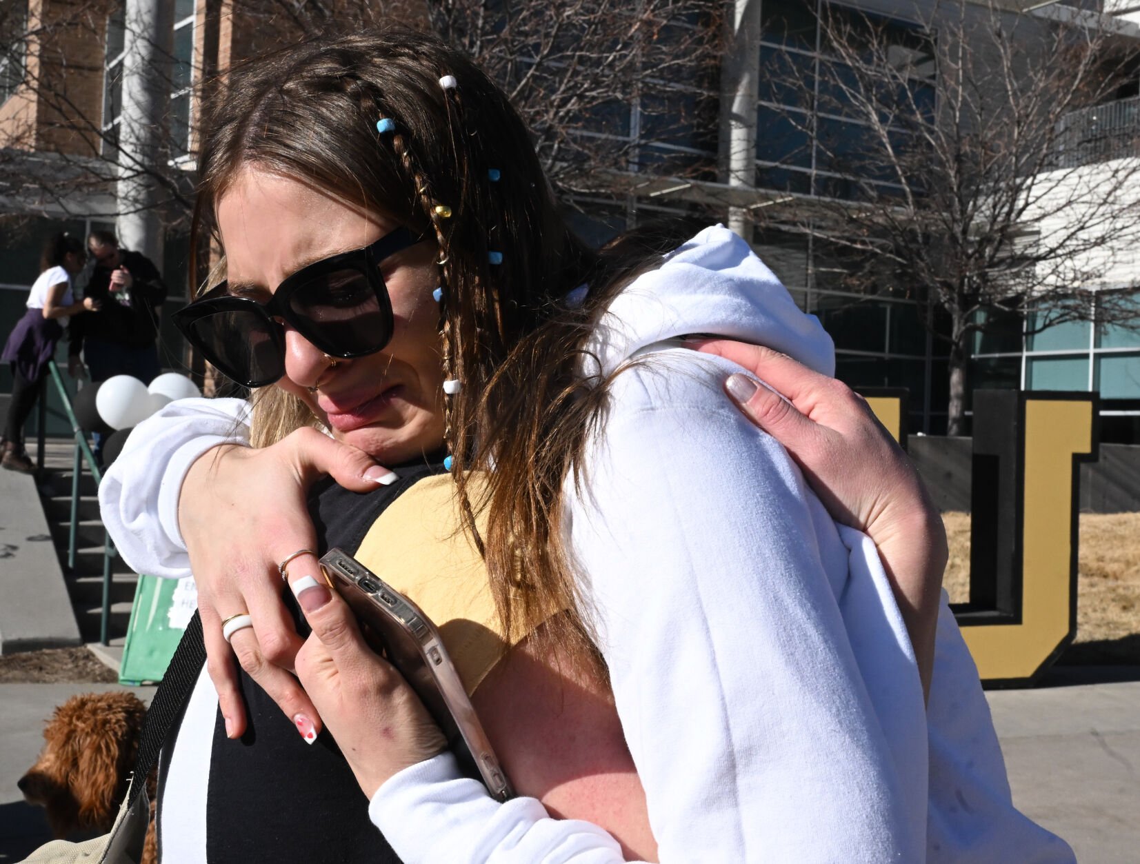 UCCS student Willow Kitchens gives an emotional hug to a friend after a Healing Walk at UCCS on Monday, Feb. 19, 2024. Kitchens was friends with Sam Knopp, one of the victims of a double homicide in a dorm last week. A suspect was arrested Monday. Also, a student suddenly died from a medical issue several days before the murders. (Photo by Jerilee Bennett, The Gazette)