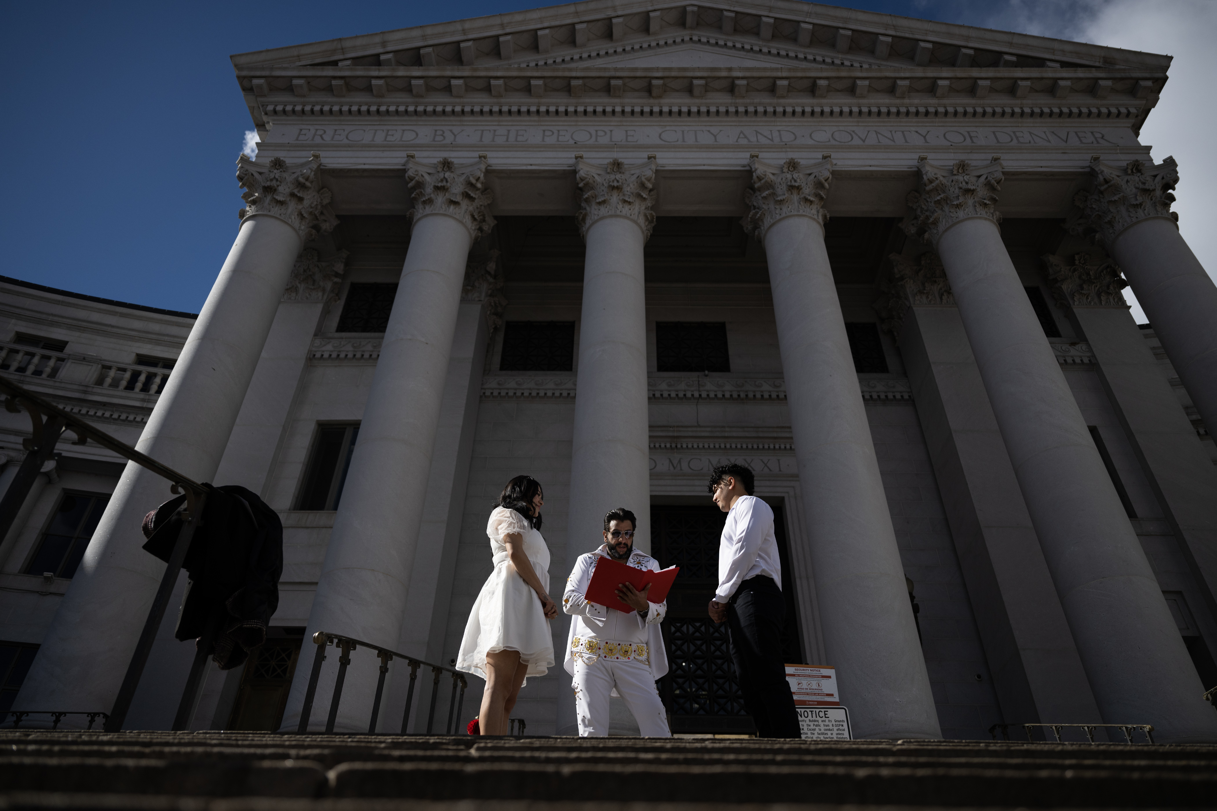 Denver Clerk and Recorder Paul López, dressed as Elvis Presley for the occasion, officiates the wedding of Ingrid, left, and Osama Zayed on the steps of the Denver City and County Building during the 16th annual Marriage Marathon on Wednesday, Feb. 14, 2024, in Denver, Colo. (Timothy Hurst/Denver Gazette) (TimHursttim.hurst@gazette.comhttps://secure.gravatar.com/avatar/aca82bd62b4ee425c598527cd6faa1b1?d=mm&r=g)