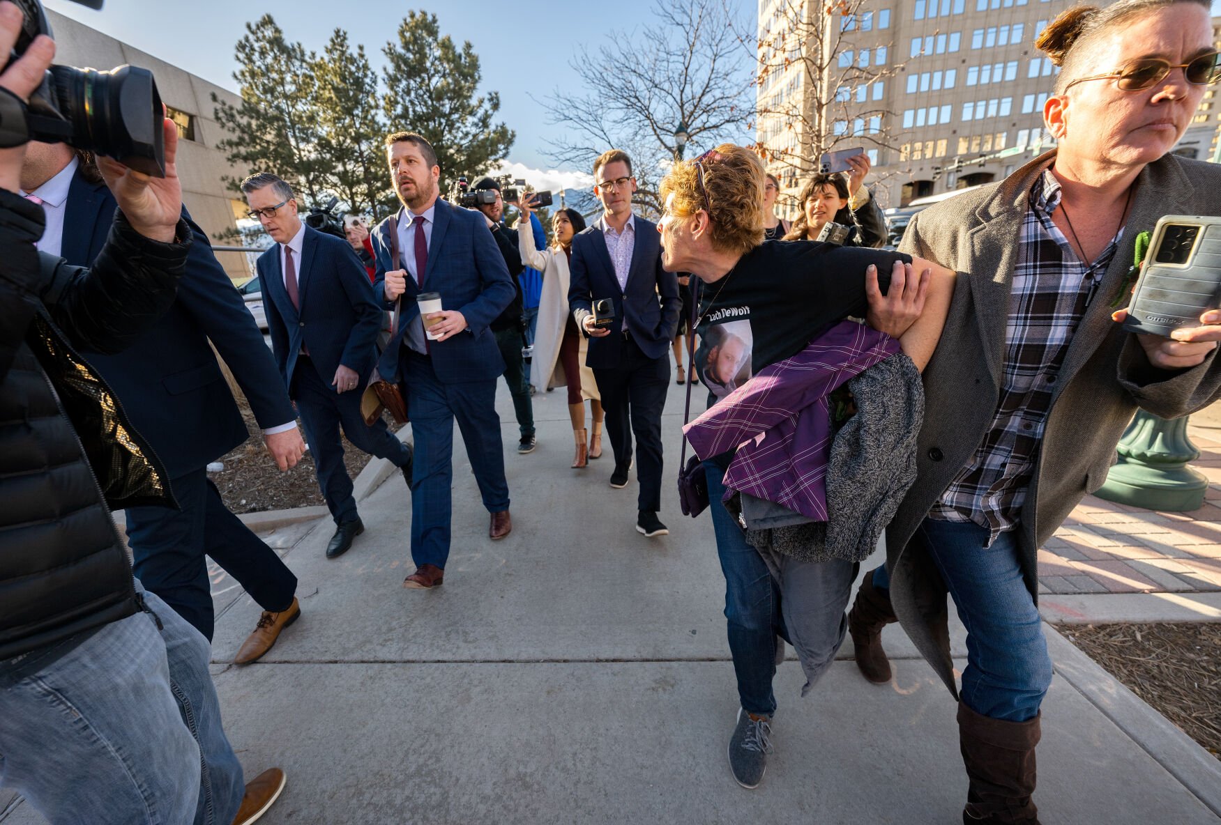Chrystina Page, right, holds back Heather De Wolf, as she yells at Jon Hallford, left, the Return to Nature co-owner facing hundreds of felony charges after the discovery of 189 improperly stored bodies, leaves his preliminary hearing with his lawyers Thursday, Feb. 8, 2024, outside the El Paso County Judicial Building in Colorado Springs. De Wolf and Page are mothers of sons believed to be among the bodies found at the funeral home. (The Gazette, Christian Murdock) (Christian Murdock/The Gazette)