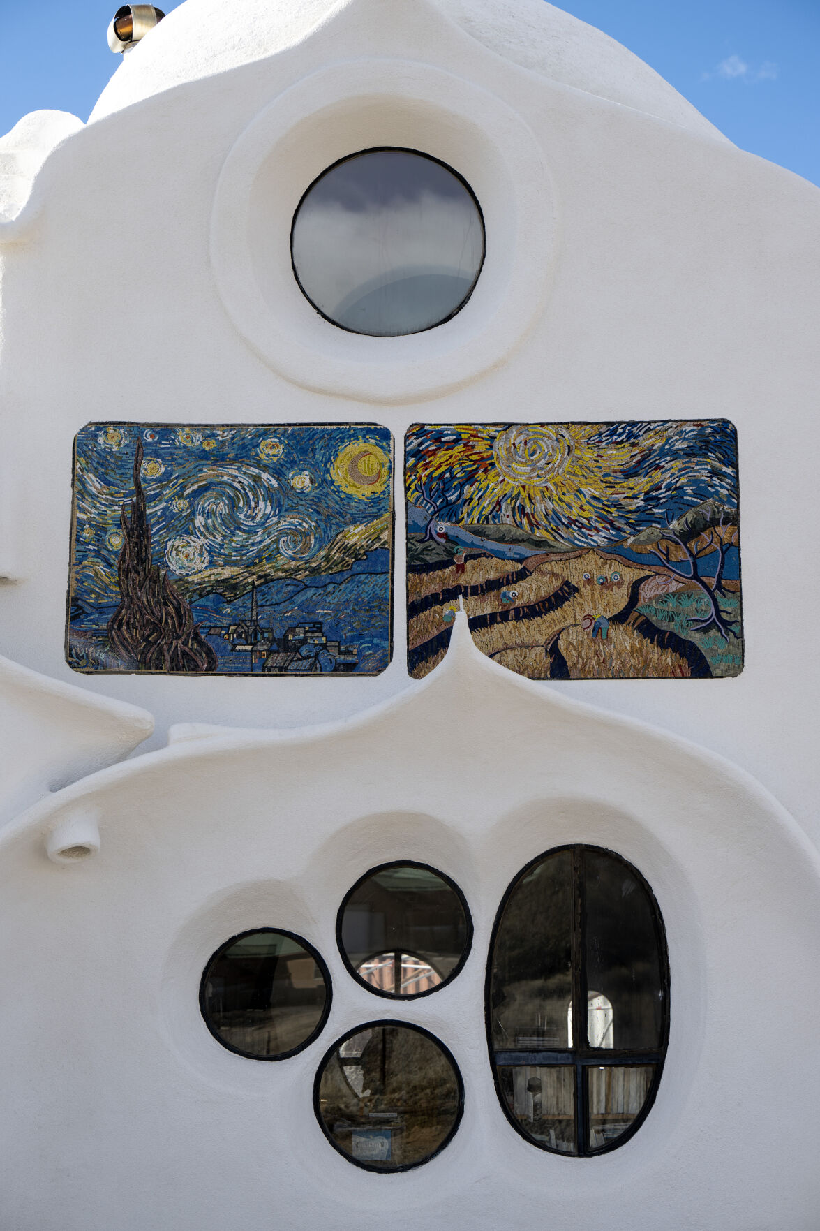 LEFT: Tile murals and windows on the exterior of the Crestone Hobbitat. (Parker Seibold)