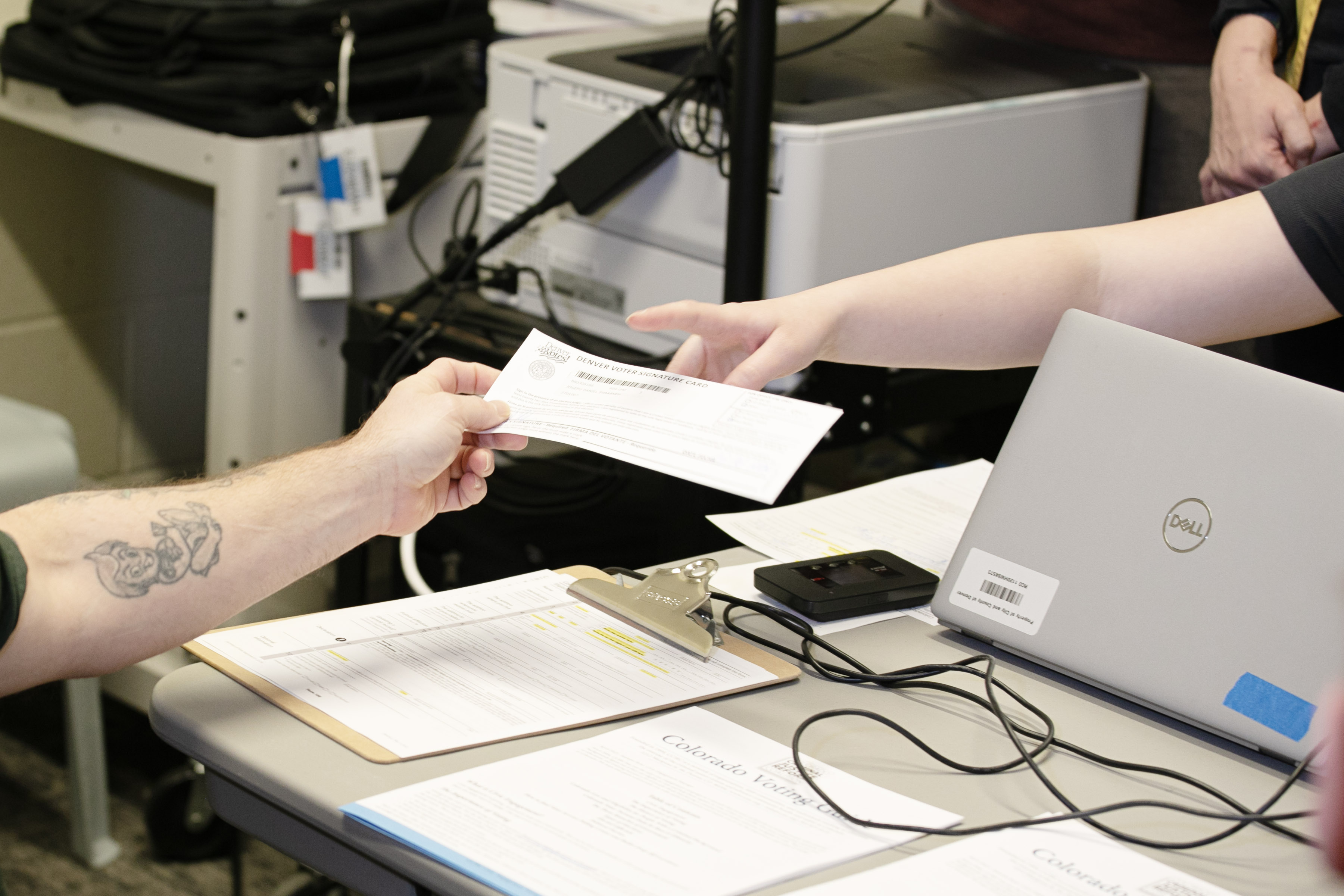 Joseph Shaabneh, left, hands in his voter signature card to election officials before casting his ballot at the Downtown Detention Center on Wednesday, Feb. 28, 2024. Election officials are manning polling places for inmates in the facility on Wednesday and for the Denver County Jail Thursday. (TomHellauerMultimedia Producertom.hellauer@denvergazette.comhttps://denvergazette.com/content/tncms/avatars/f/9e/622/f9e6228a-3b6b-11ed-bf10-fbb71fa8e421.f54b911252c540f1d61709edc4727a39.png)
