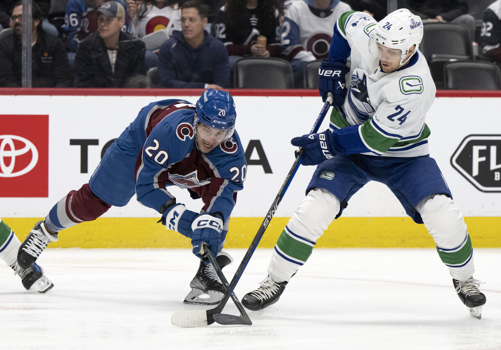 Colorado Avalanche center Ross Colton (20) battles Vancouver Canucks center Pius Suter (24) for the puck during the first period Tuesday, Feb. 20, 2024, at Ball Arena in Denver. (The Gazette, Christian Murdock) (Christian Murdock/The Gazette)