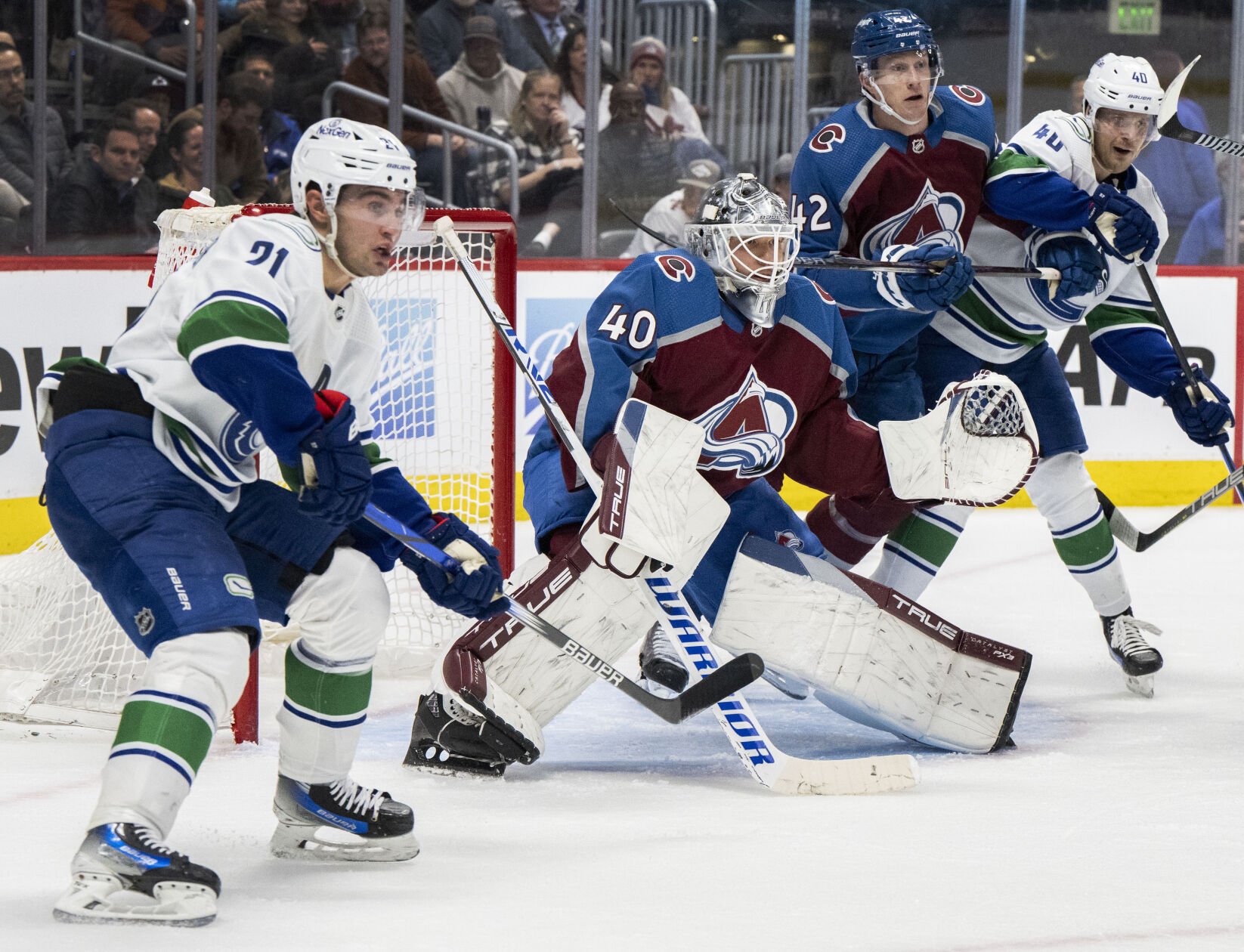 Colorado Avalanche goaltender Alexandar Georgiev (40) defends the goal against Vancouver Canucks left wing Nils Hoglander (21) and center Elias Pettersson (40) during the second period Tuesday, Feb. 20, 2024, at Ball Arena in Denver. (The Gazette, Christian Murdock) (Christian Murdock/The Gazette)
