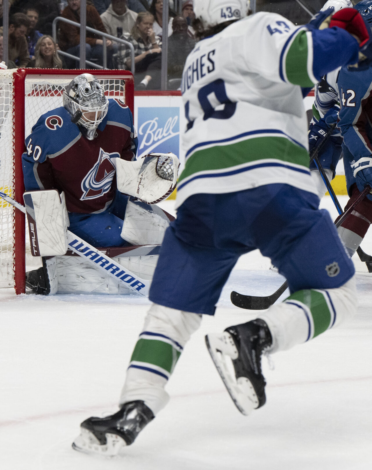 Colorado Avalanche goaltender Alexandar Georgiev (40) stops a shot by Vancouver Canucks defenseman Quinn Hughes (43) with his mask during the second period Tuesday, Feb. 20, 2024, at Ball Arena in Denver. (The Gazette, Christian Murdock) (Christian Murdock/The Gazette)