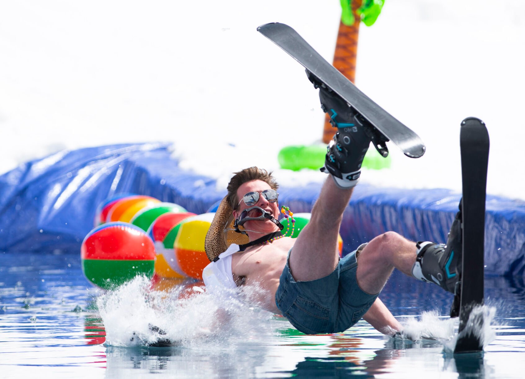 A skier crashes into the cold water Saturday, April 2, 2022, during the 2022 Pond Skim on the closing weekend of skiing at Crested Butte Mountain Resort. (The Gazette, Christian Murdock) (Christian Murdock/The Gazette)