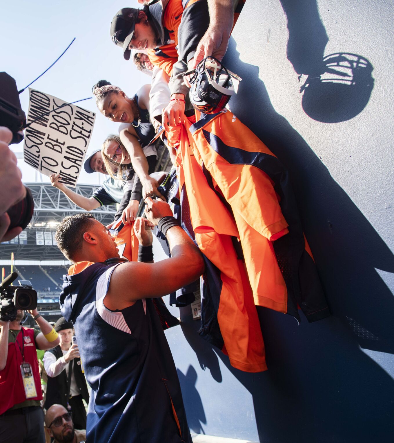 Denver Broncos quarterback Russell Wilson (3) signs autographers for fans at Lumen Field in Seattle before the start of the Broncos season opener against his former team Monday, Sept. 12, 2022, in Seattle. (The Gazette, Christian Murdock) (Christian Murdock)