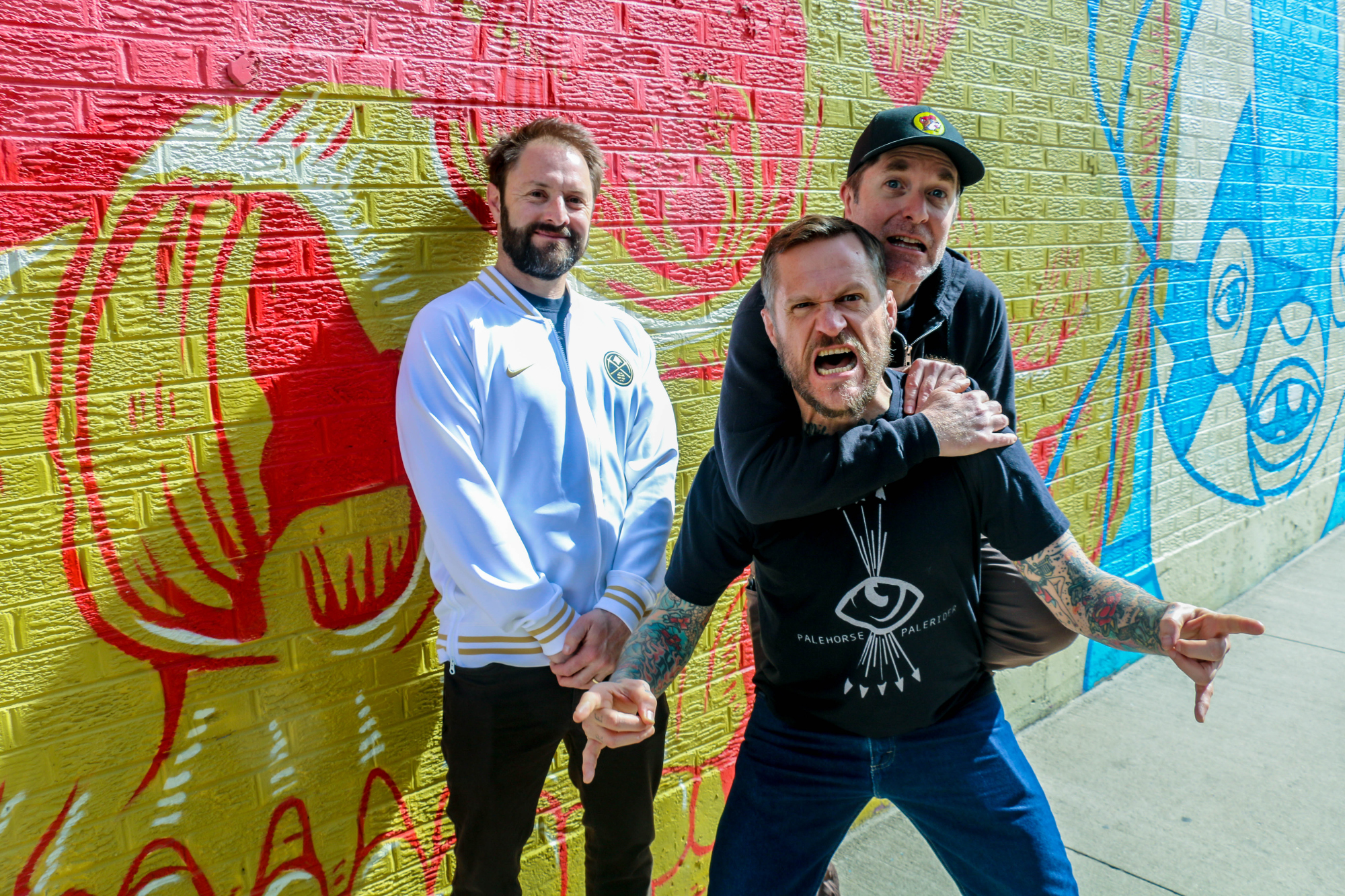 The Grawlix have been repping Denver locally and nationally as a designated comedy supertrio since 2011. From left, Adam Cayton-Holland, Ben Roy and Andrew Orvedahl. Photographed March 3, 2024, at Illegal Pete's on Colfax Avenue. (John Moore, The Denver Gazette)