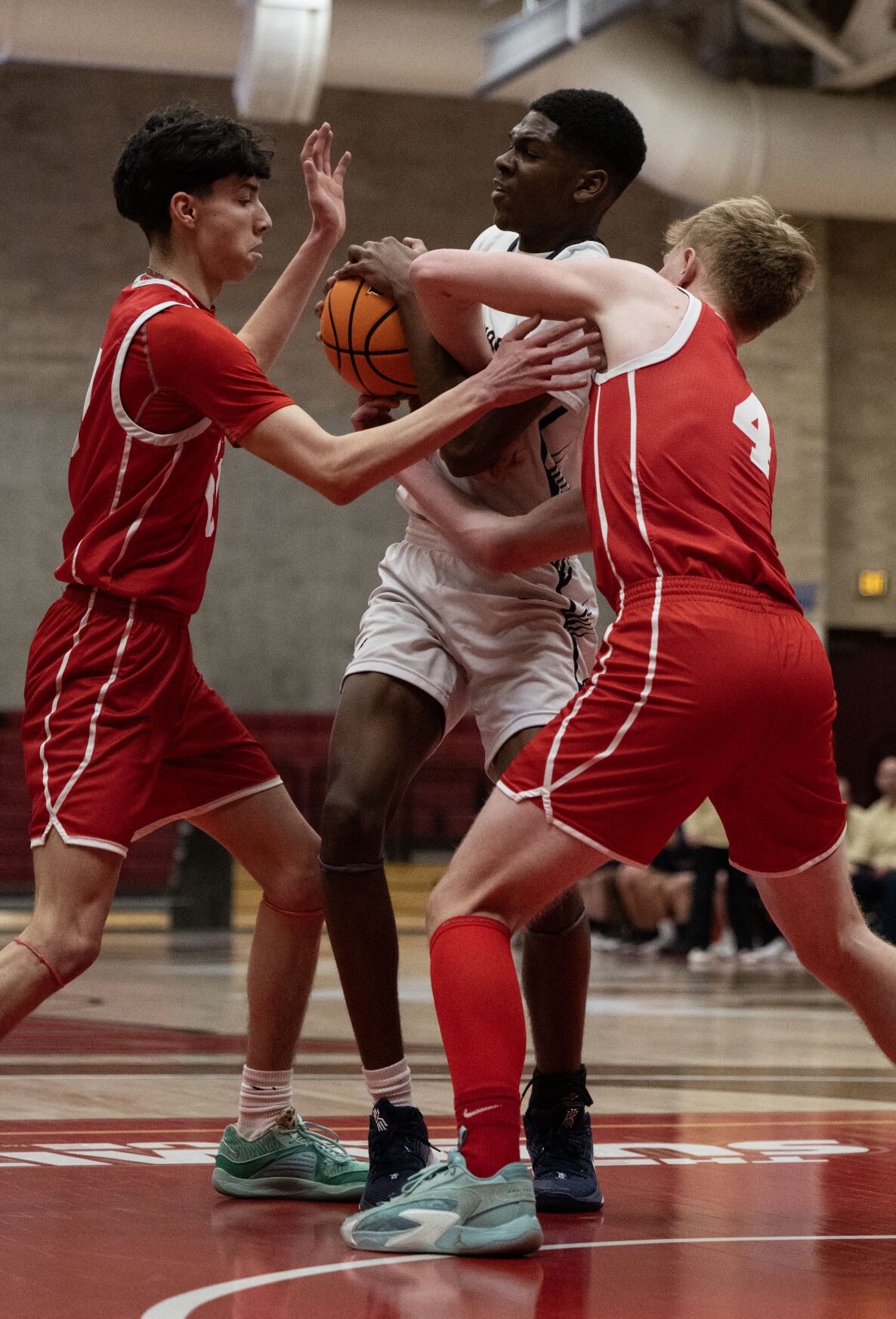 Vanguard’s Matty Dessalegn (0) fights Yuma’s Edwin Munoz (10) and Jonathan Thomson (4) for possession of the ball in the first half of the 3A boys basketball state championships on Saturday, March 9, 2024, at the University of Denver’s Hamilton Gym in Denver. (Parker Seibold, The Gazette) (Parker Seibold)