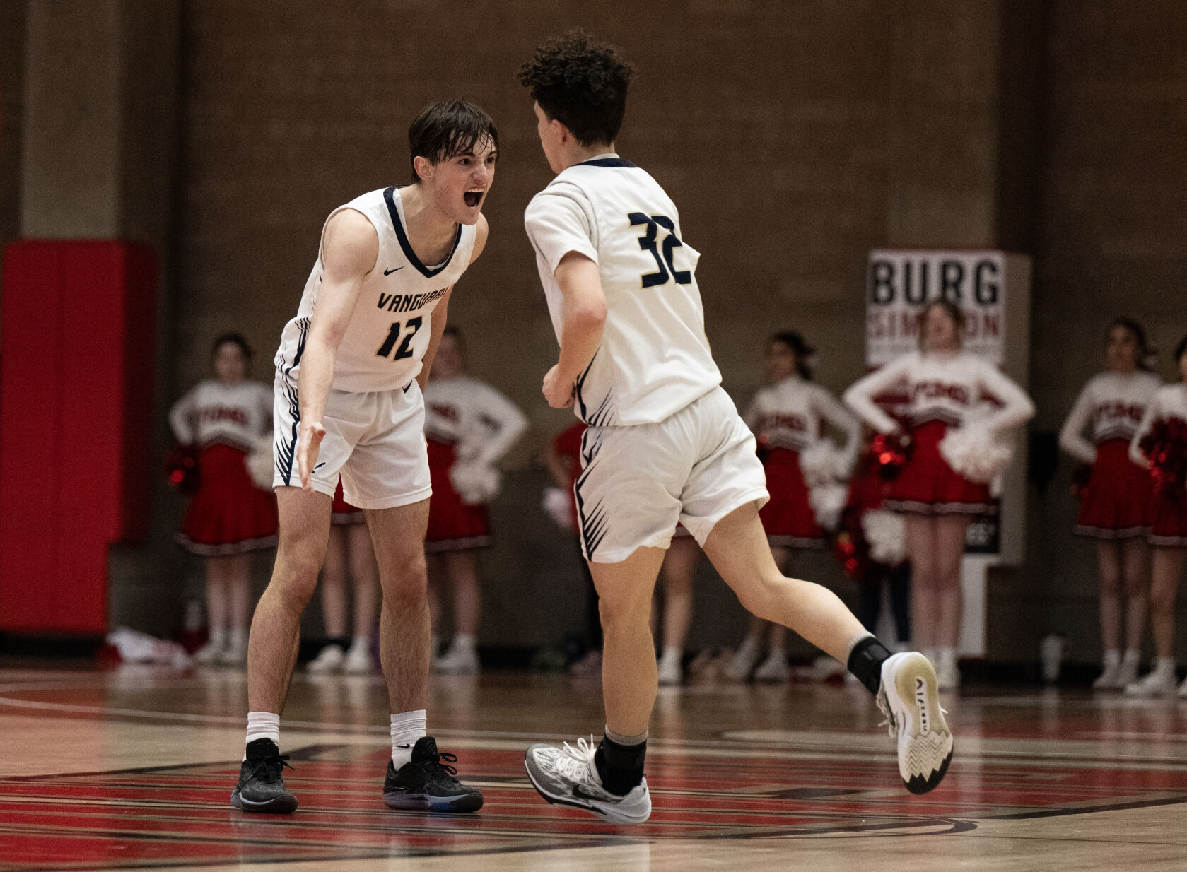 Vanguard’s Cameron Rowney (12) cheers and high-fives Jj Wetters after he made a three-point basket against Yuma in the second half of the 3A boys basketball state championships on Saturday, March 9, 2024, at the University of Denver’s Hamilton Gym in Denver. (Parker Seibold, The Gazette) (Parker Seibold)