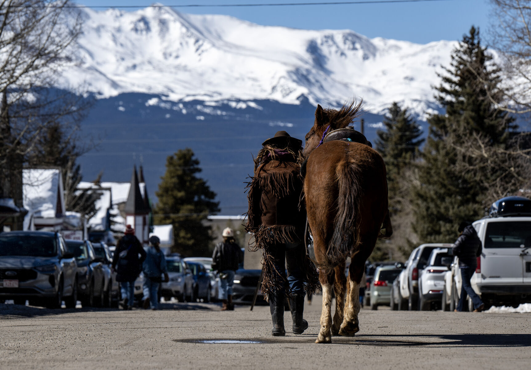 A rider walks down the street with her horse at the 76th Annual Leadville Ski Joring on Saturday, March 2, 2024, in Leadville, Colo. (Parker Seibold, The Gazette) (Parker Seibold)
