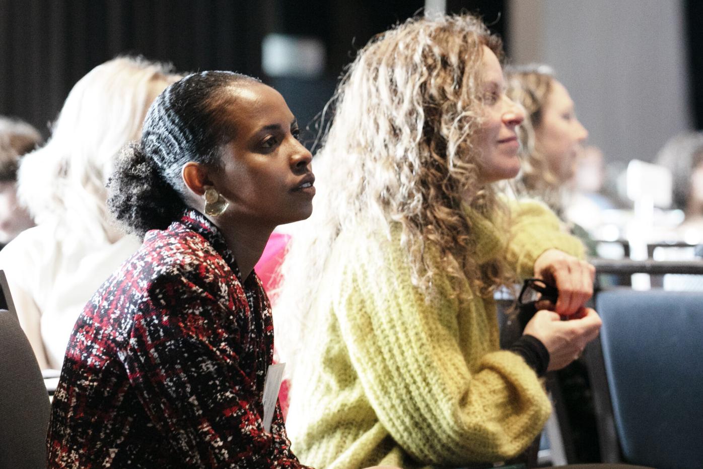 Fecha Talaso, left, and Linda Lipsius, right, listen to speakers