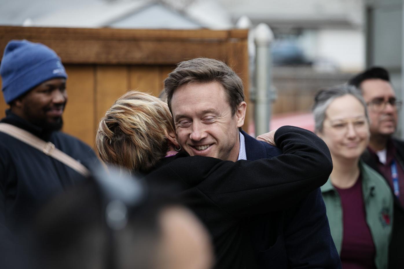 Dede de Percin, the CEO of Colorado Village Collaborative, hugs Denver Mayor Mike Johnston